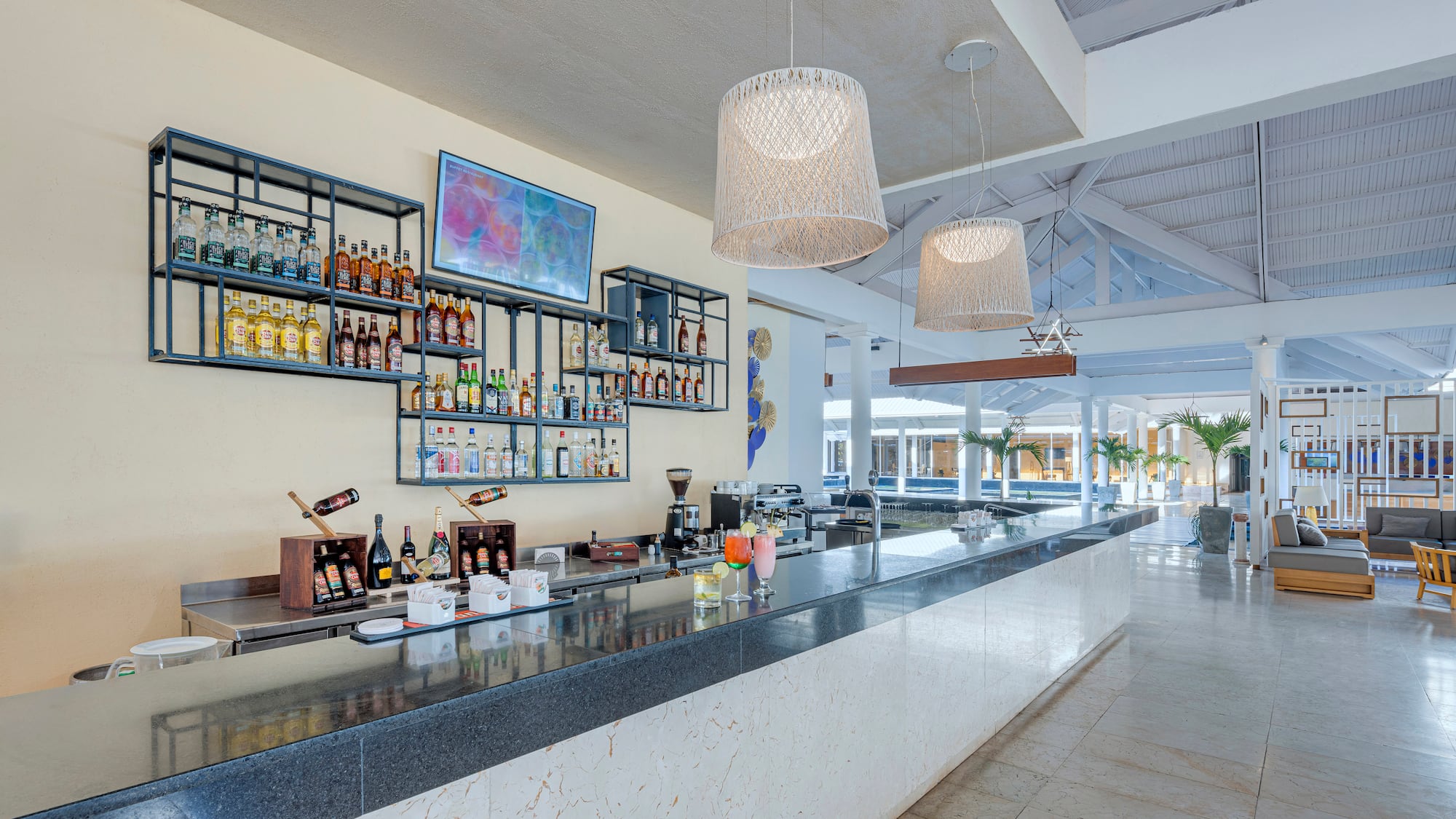 a bar with bottles of alcohol on the wall