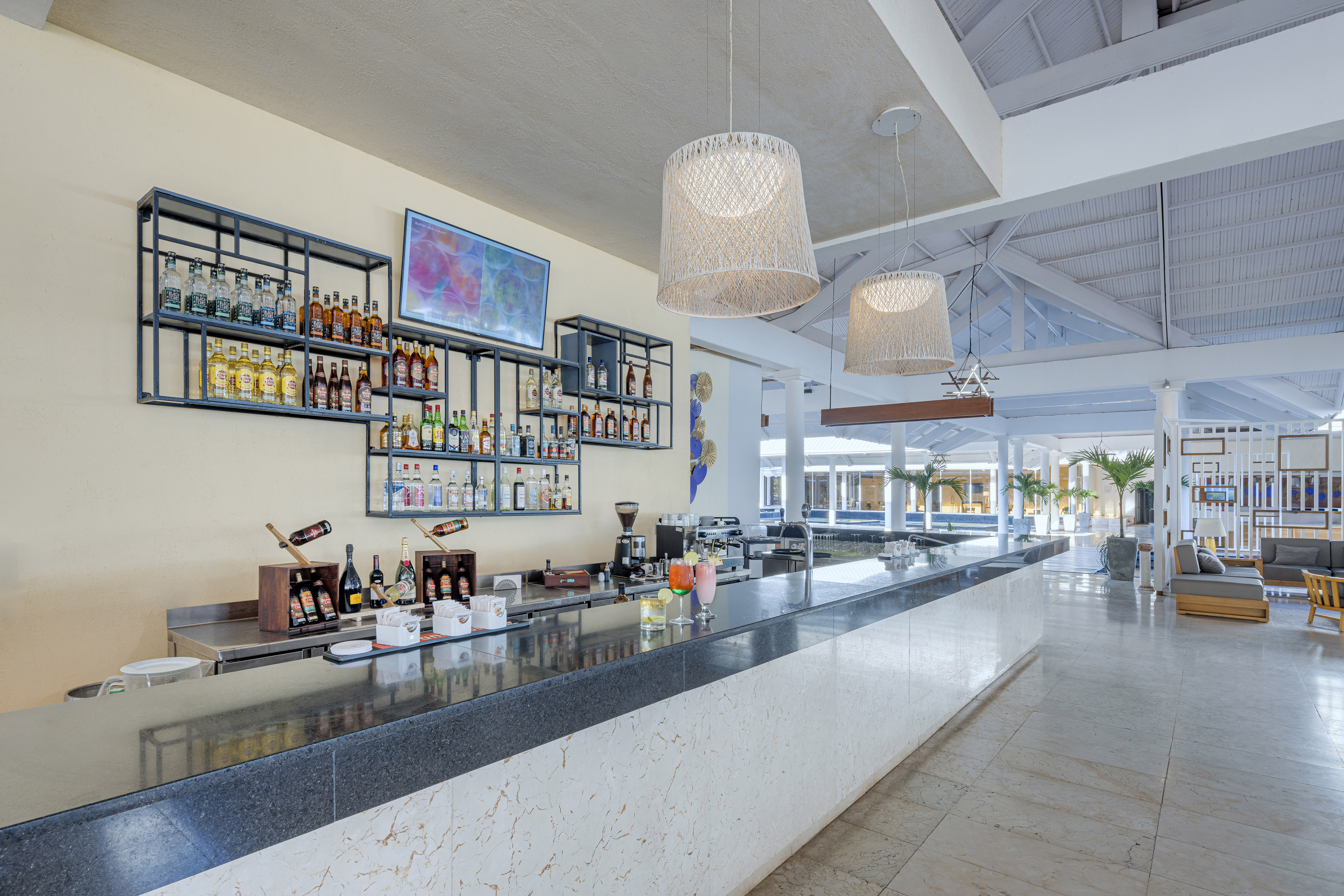 a bar with bottles of alcohol on the wall