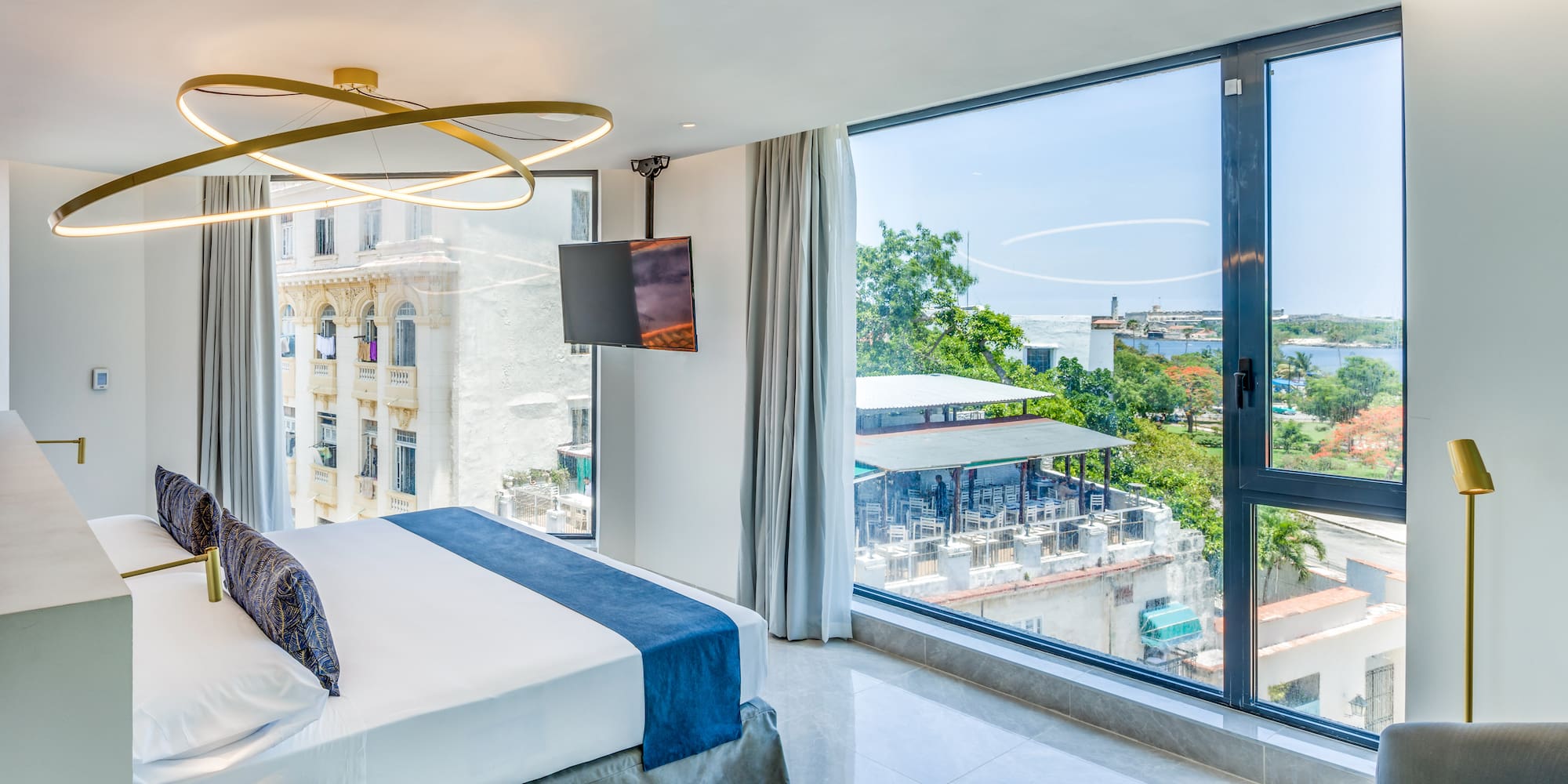 a bedroom with large windows and a bed