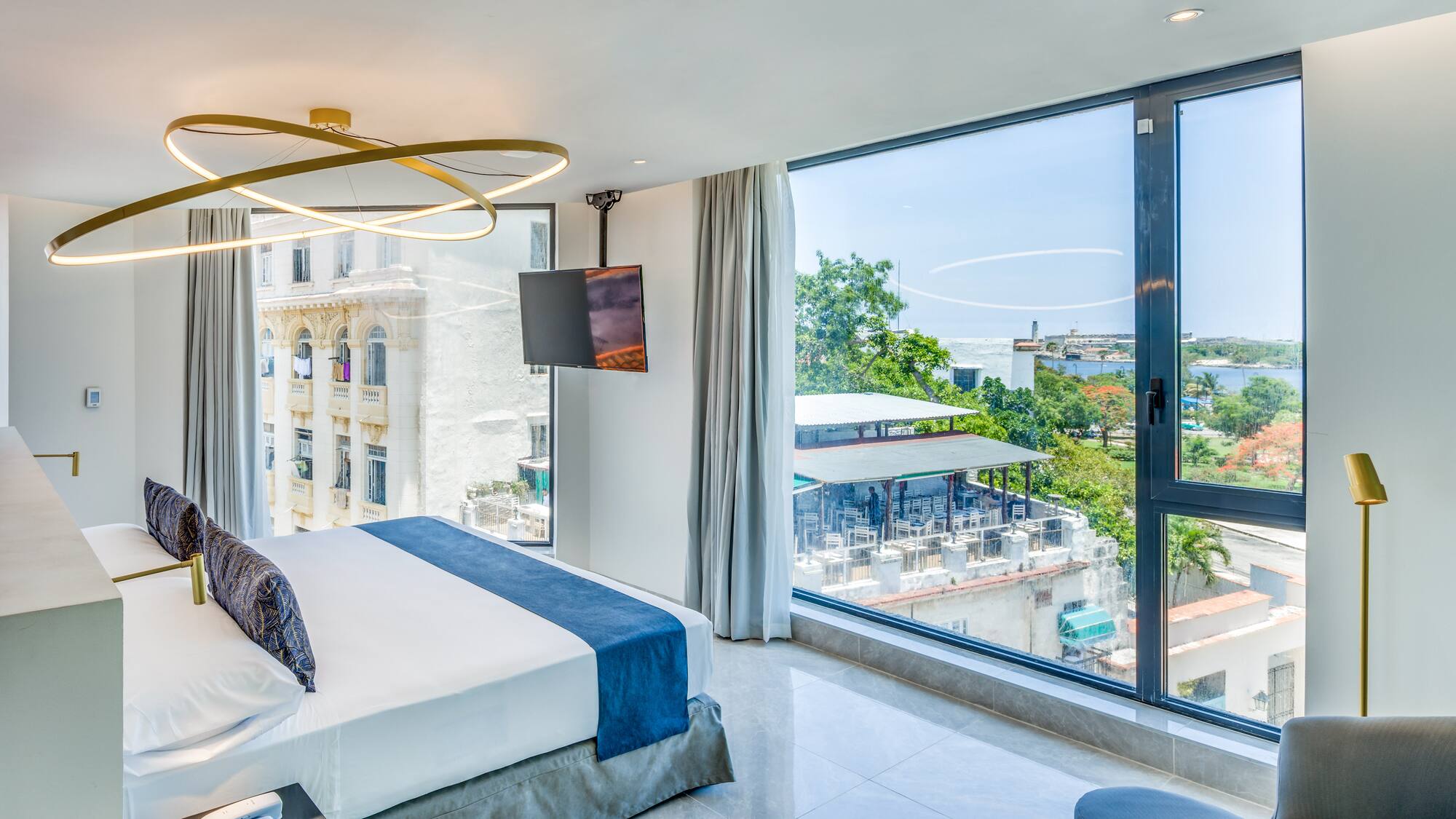 a bedroom with large windows and a bed