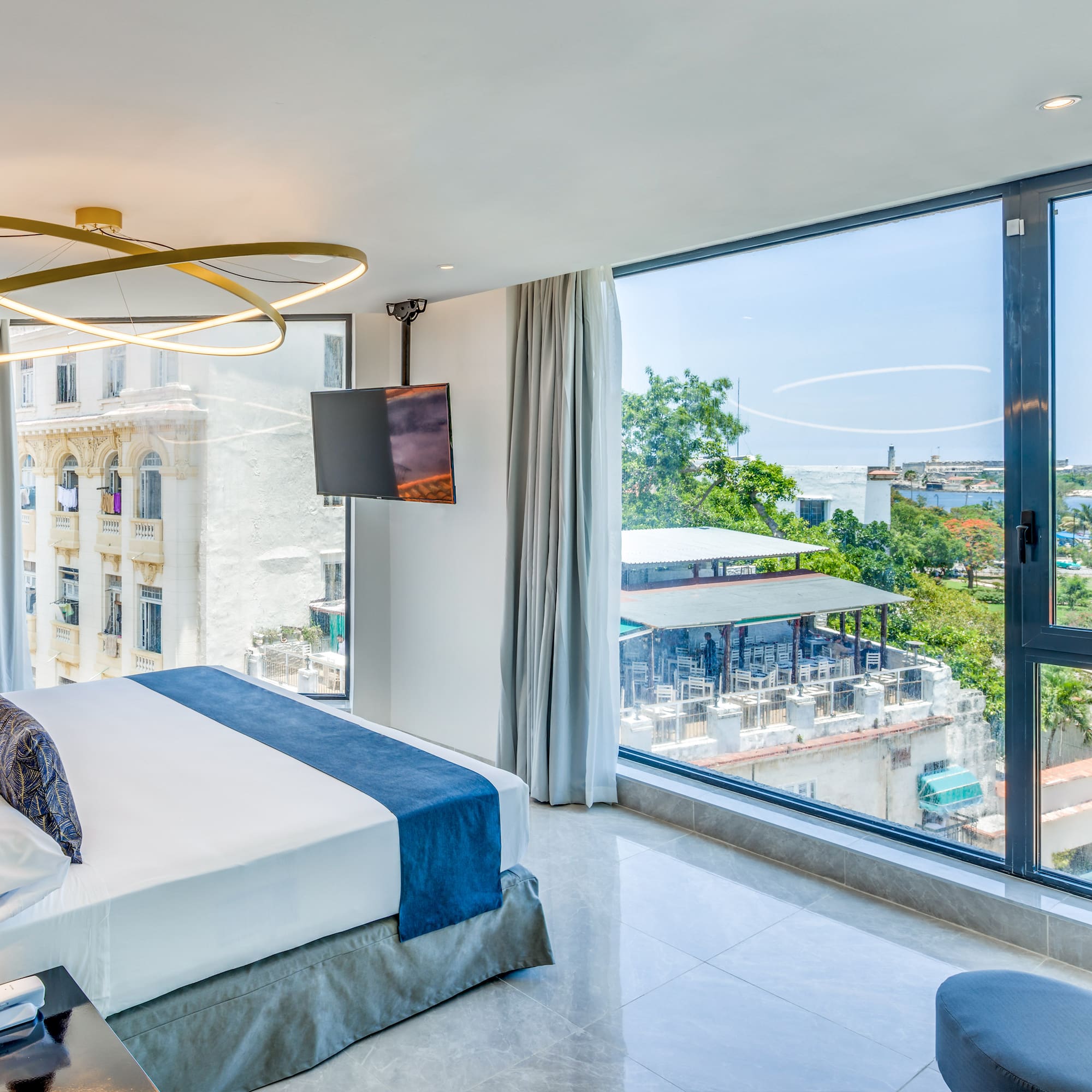 a bedroom with large windows and a bed