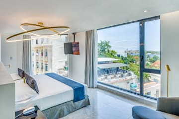 a bedroom with large windows and a bed