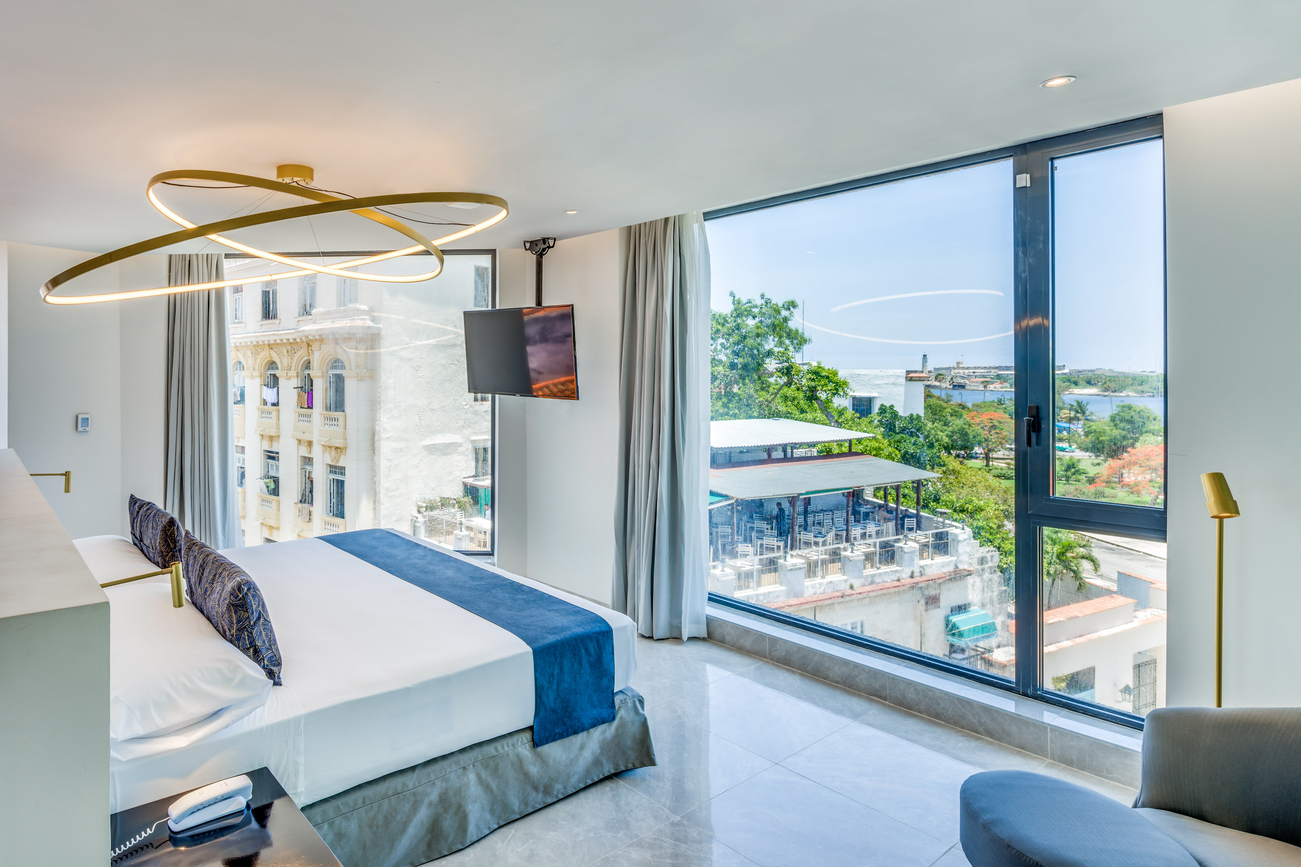 a bedroom with large windows and a bed