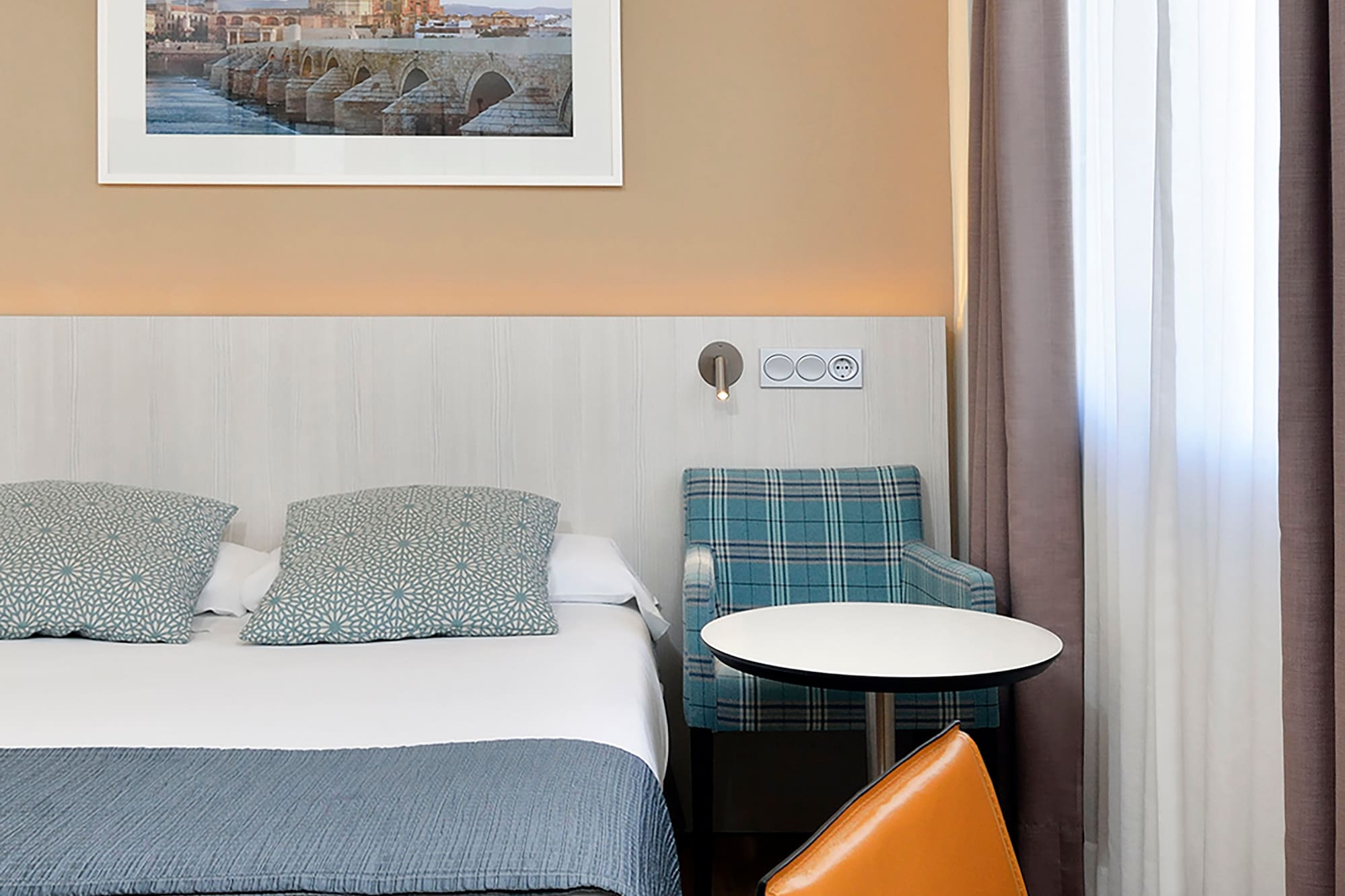 a bed with a table and chairs in a hotel room