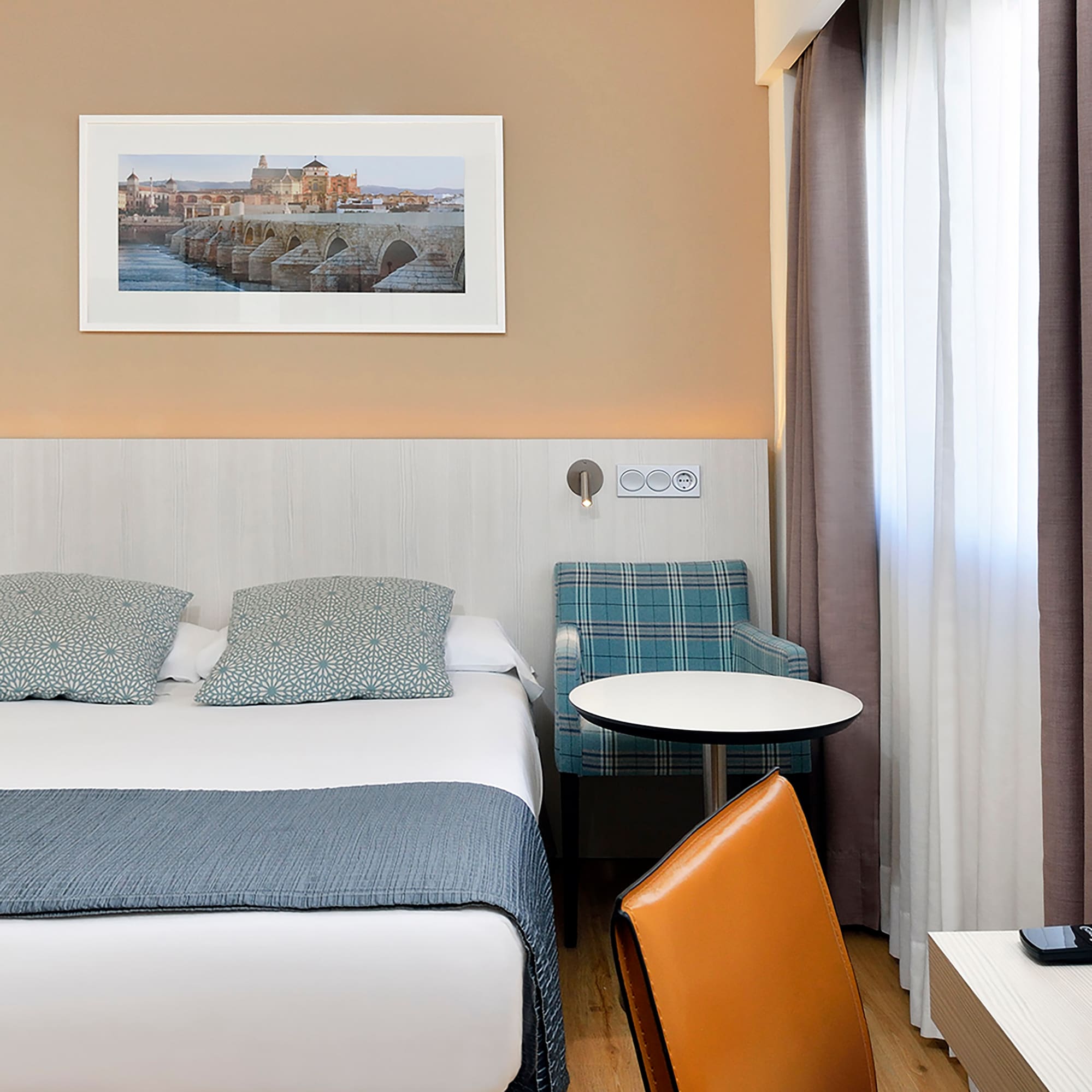 a bed with a table and chairs in a hotel room