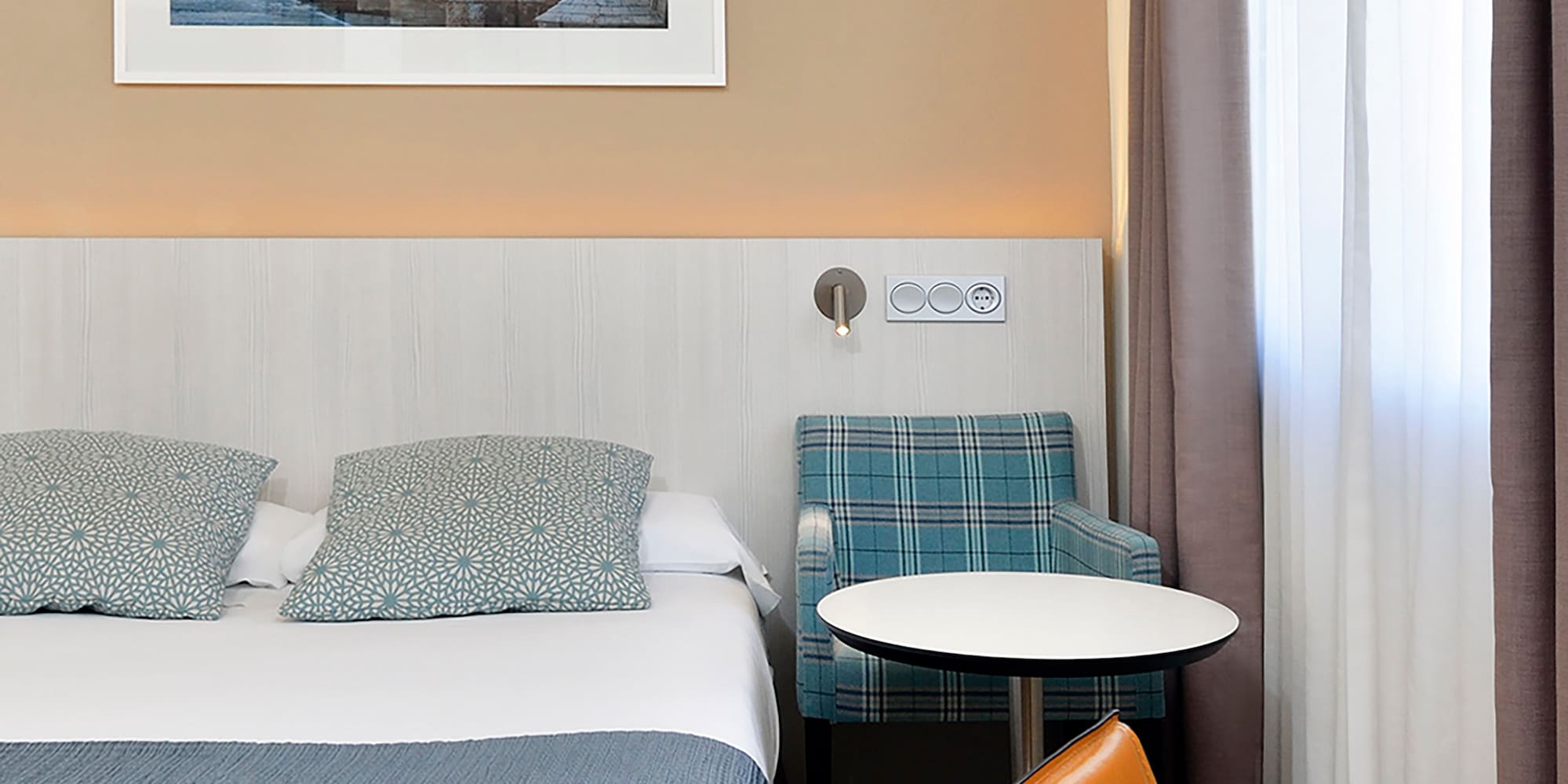 a bed with a table and chairs in a hotel room