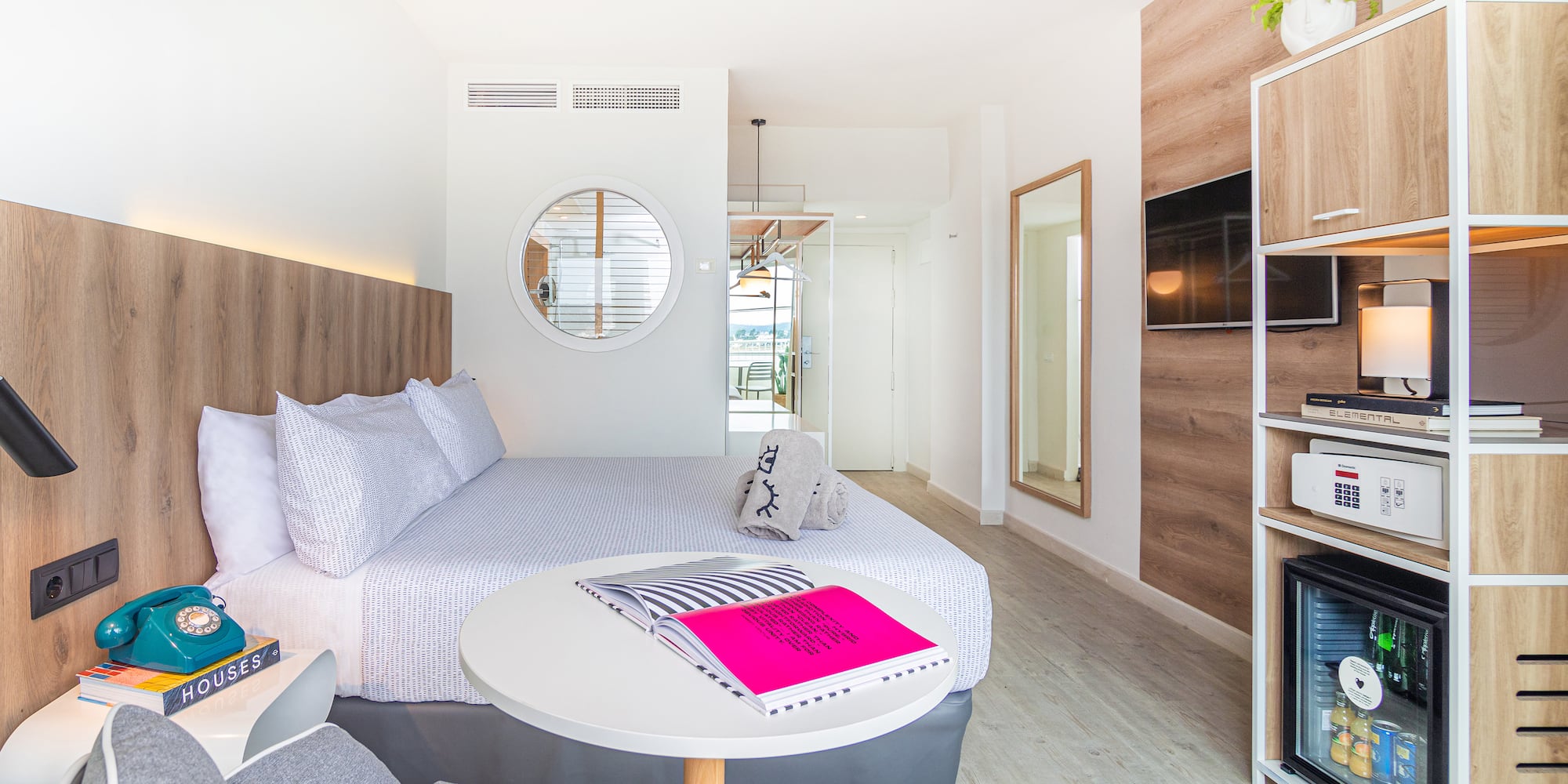 a room with a bed and a television