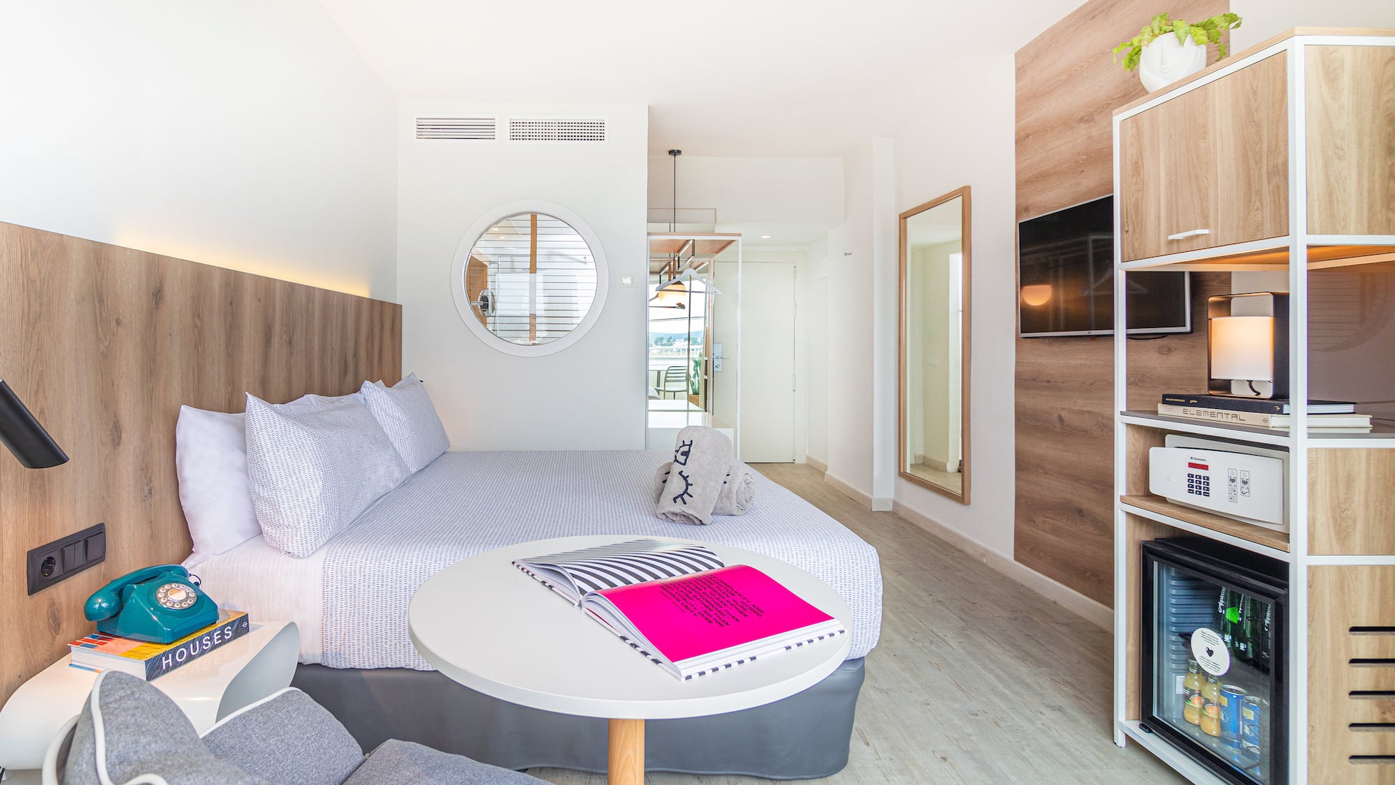 a room with a bed and a television