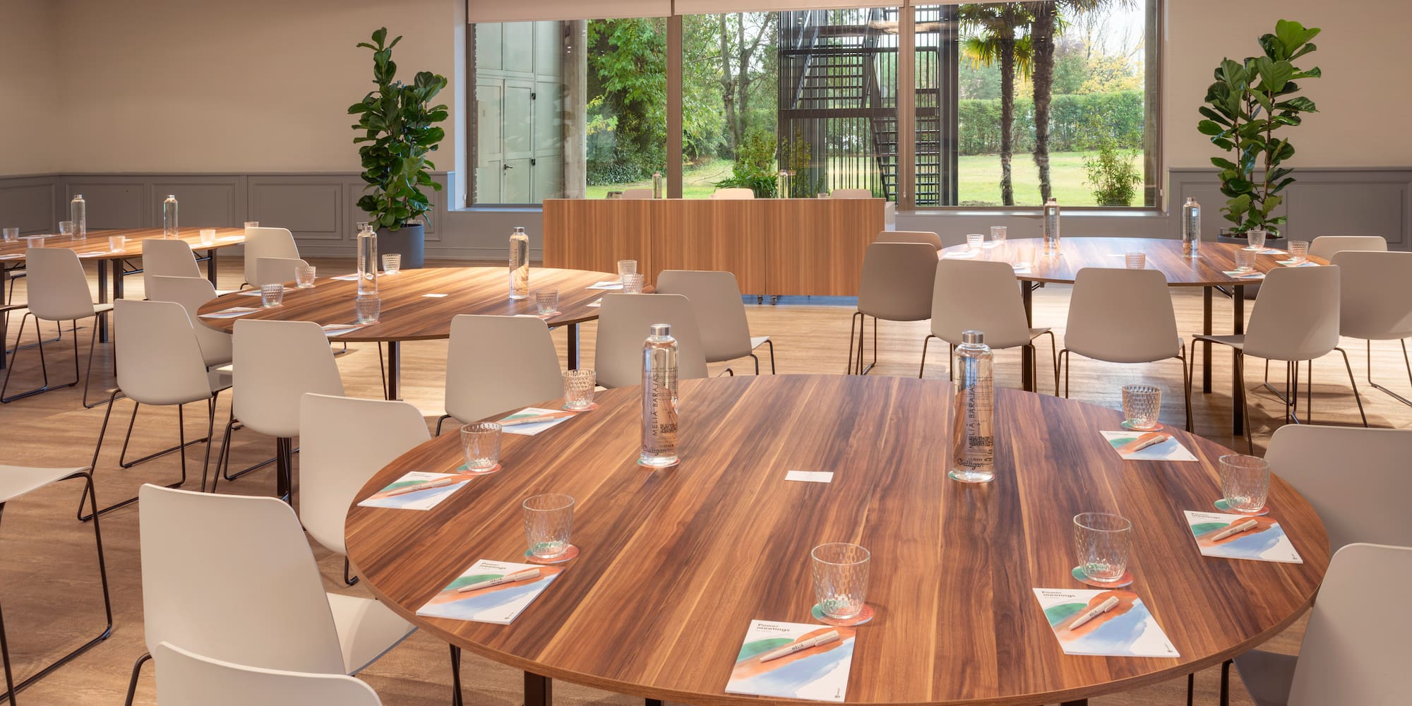 a room with a round table and chairs