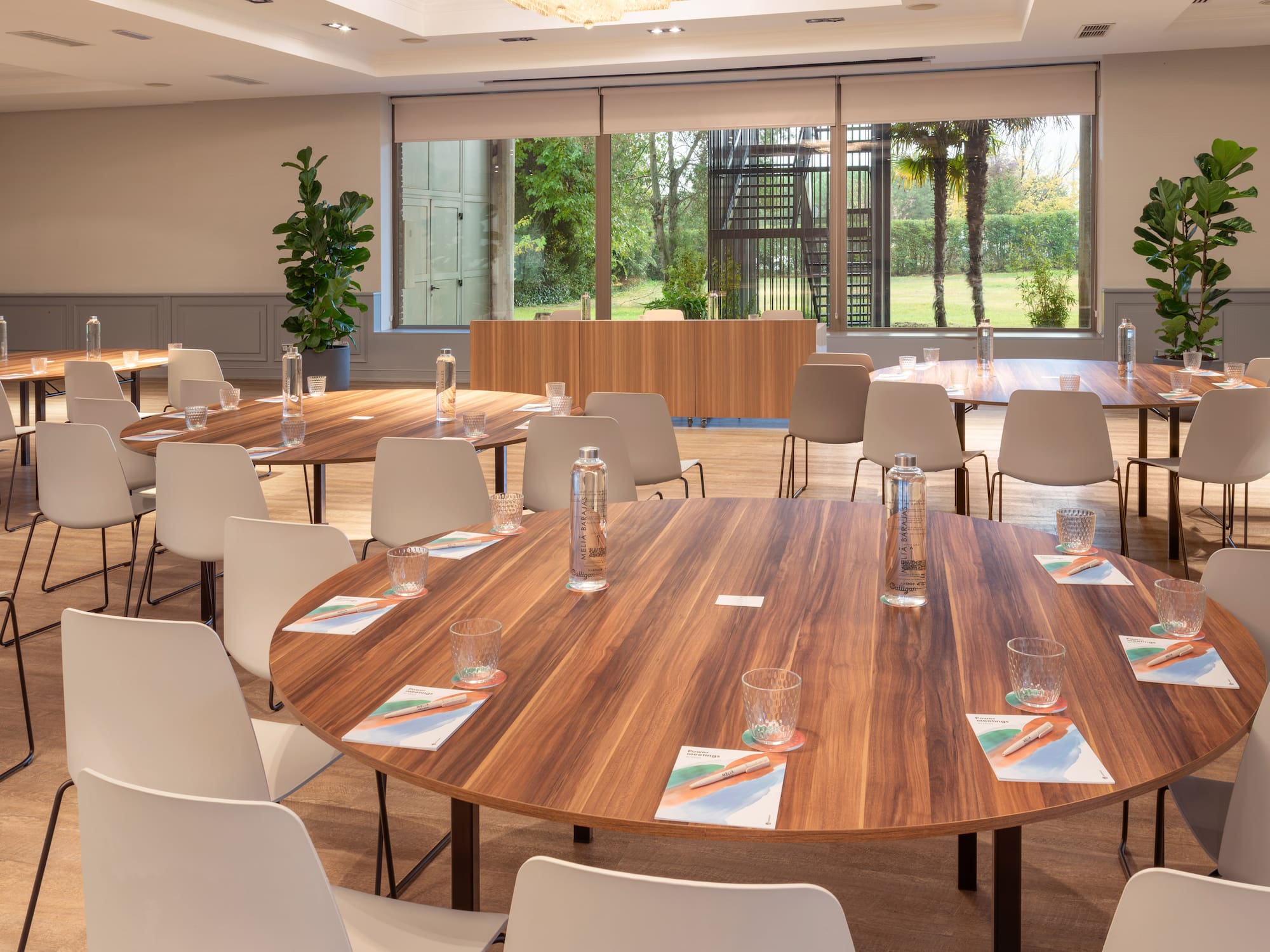 a room with a round table and chairs