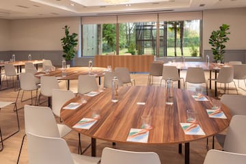 a room with a round table and chairs