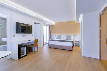 a room with a bed and a television