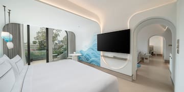 a room with a bed and a television