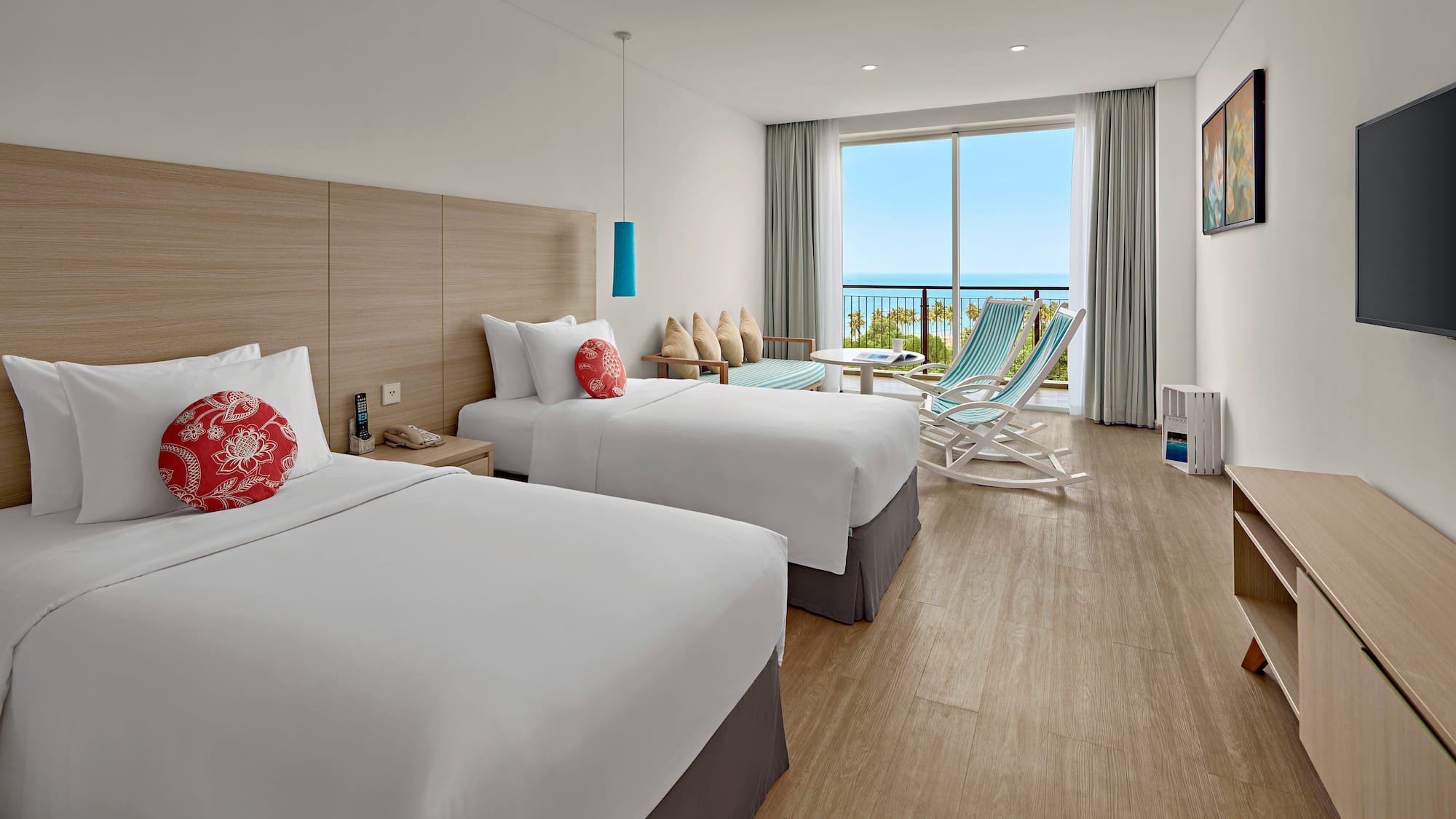 a room with two beds and chairs