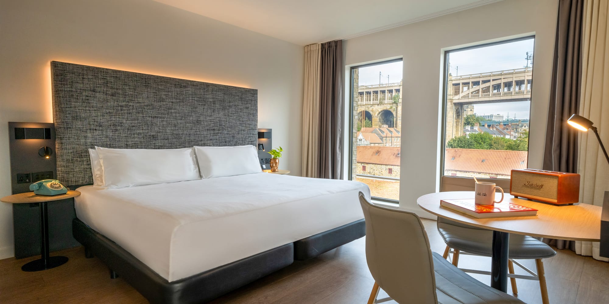 a room with a bed and a table and chairs