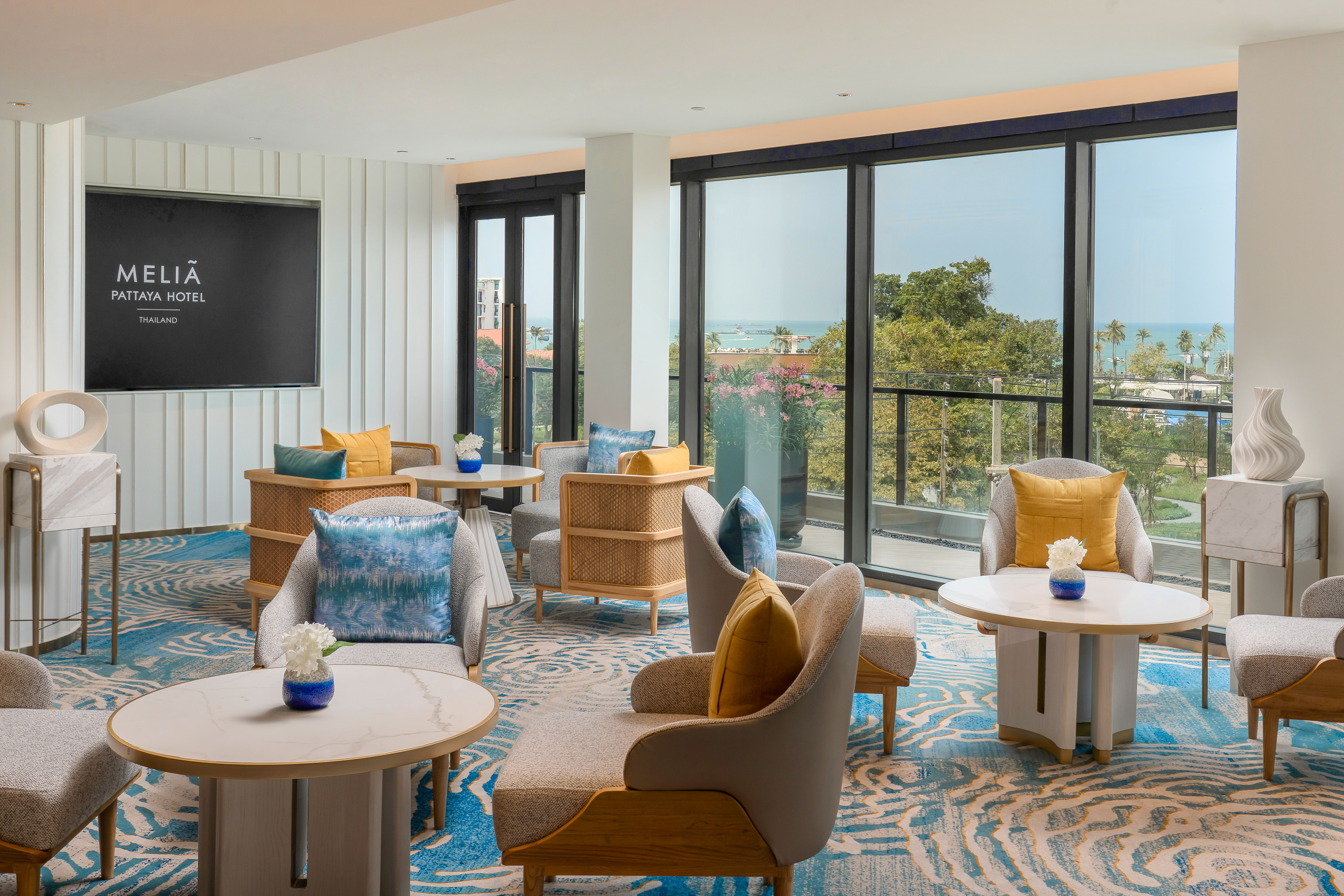 Modern Meliã Pattaya Hotel lounge with sea view and contemporary seating.