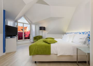 a bedroom with a bed and a television