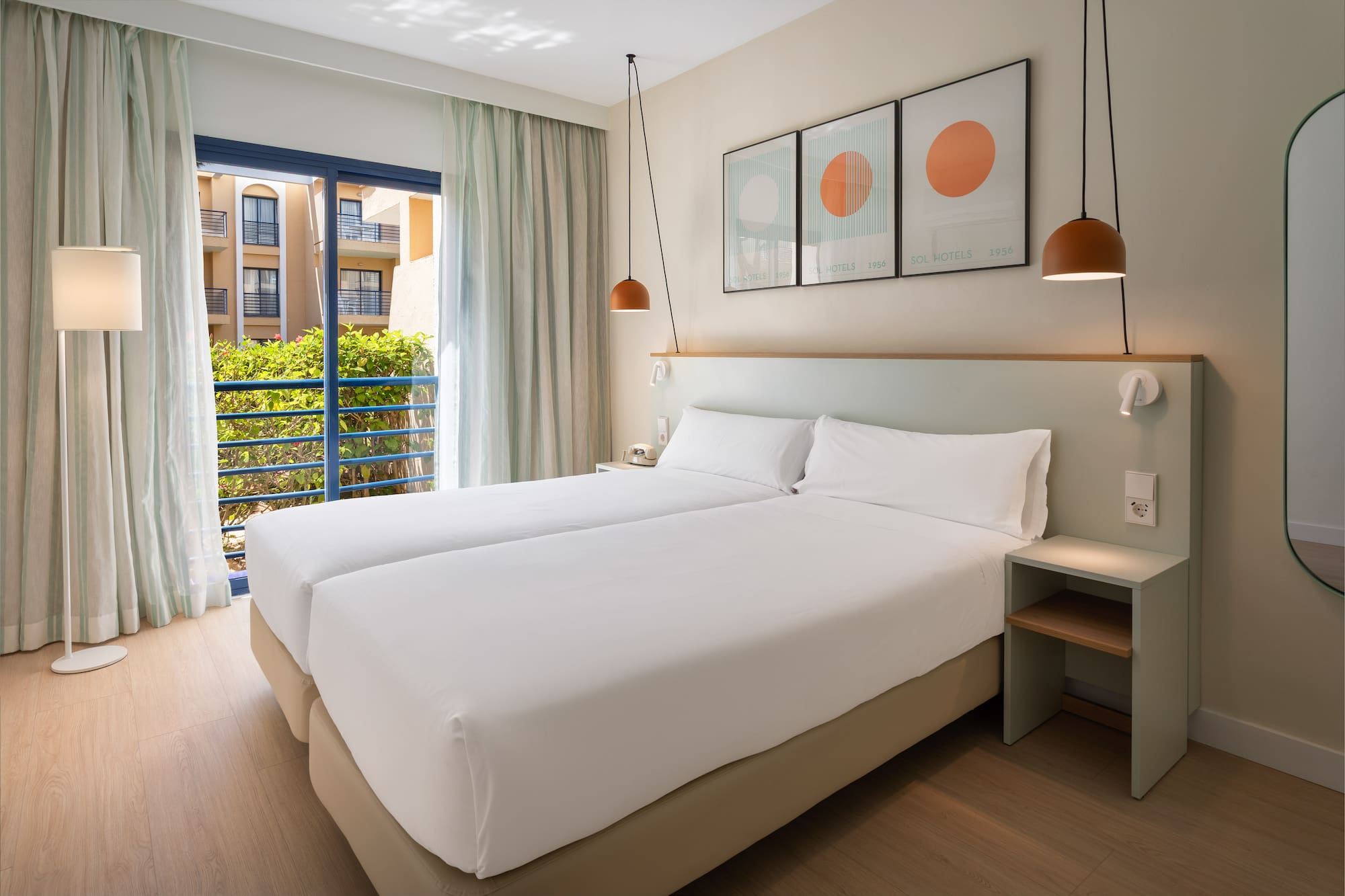 a room with two beds and a balcony