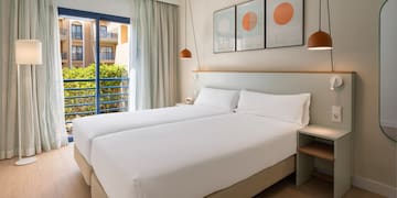 a room with two beds and a balcony