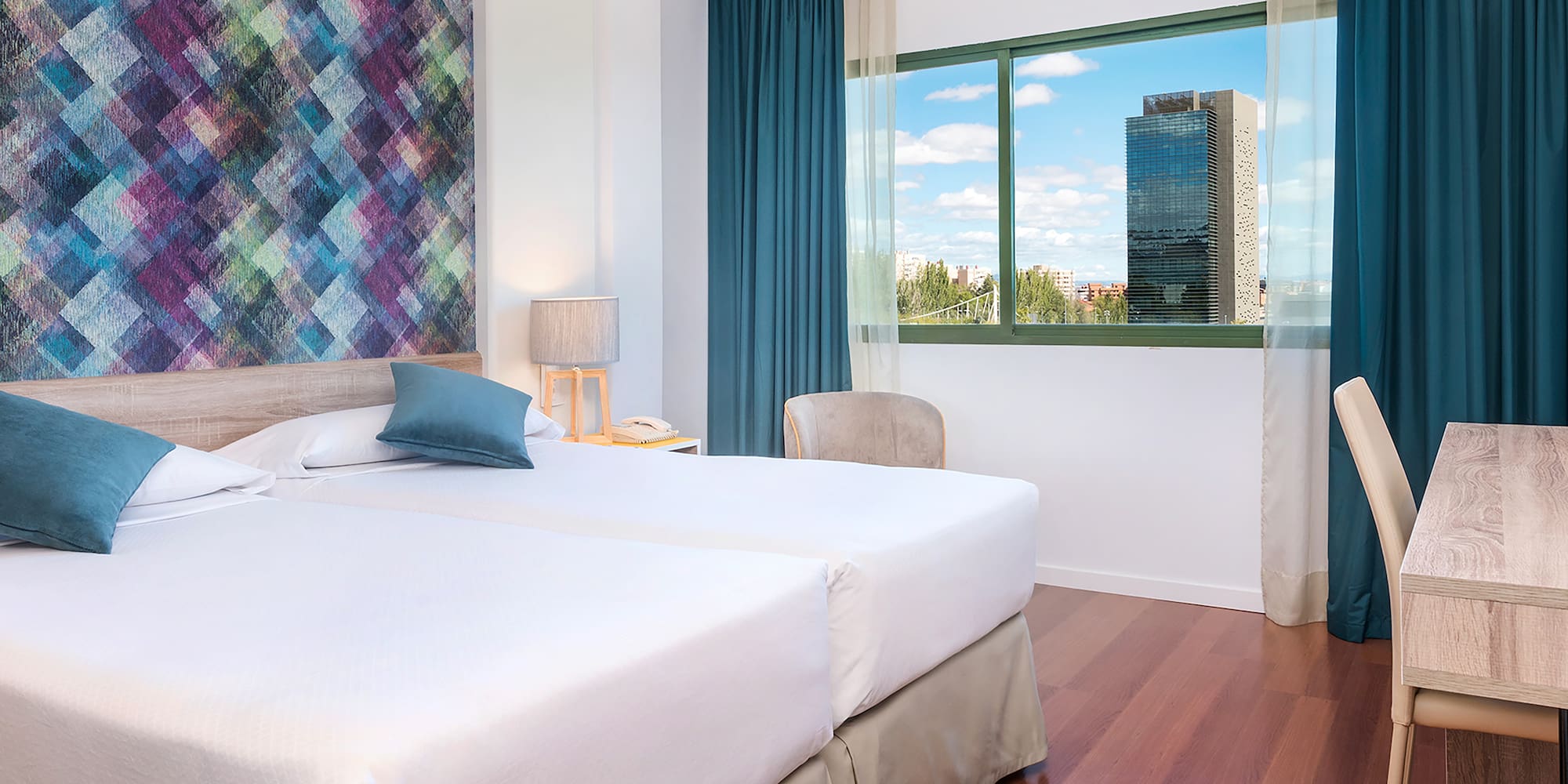 a room with two beds and a window