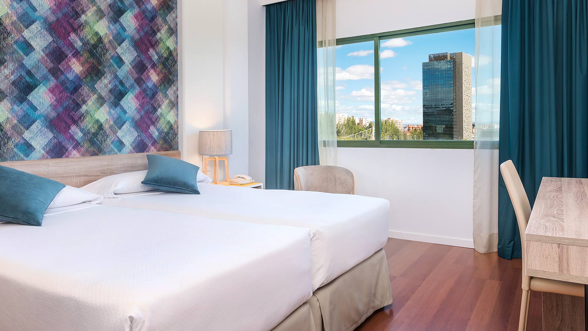 a room with two beds and a window