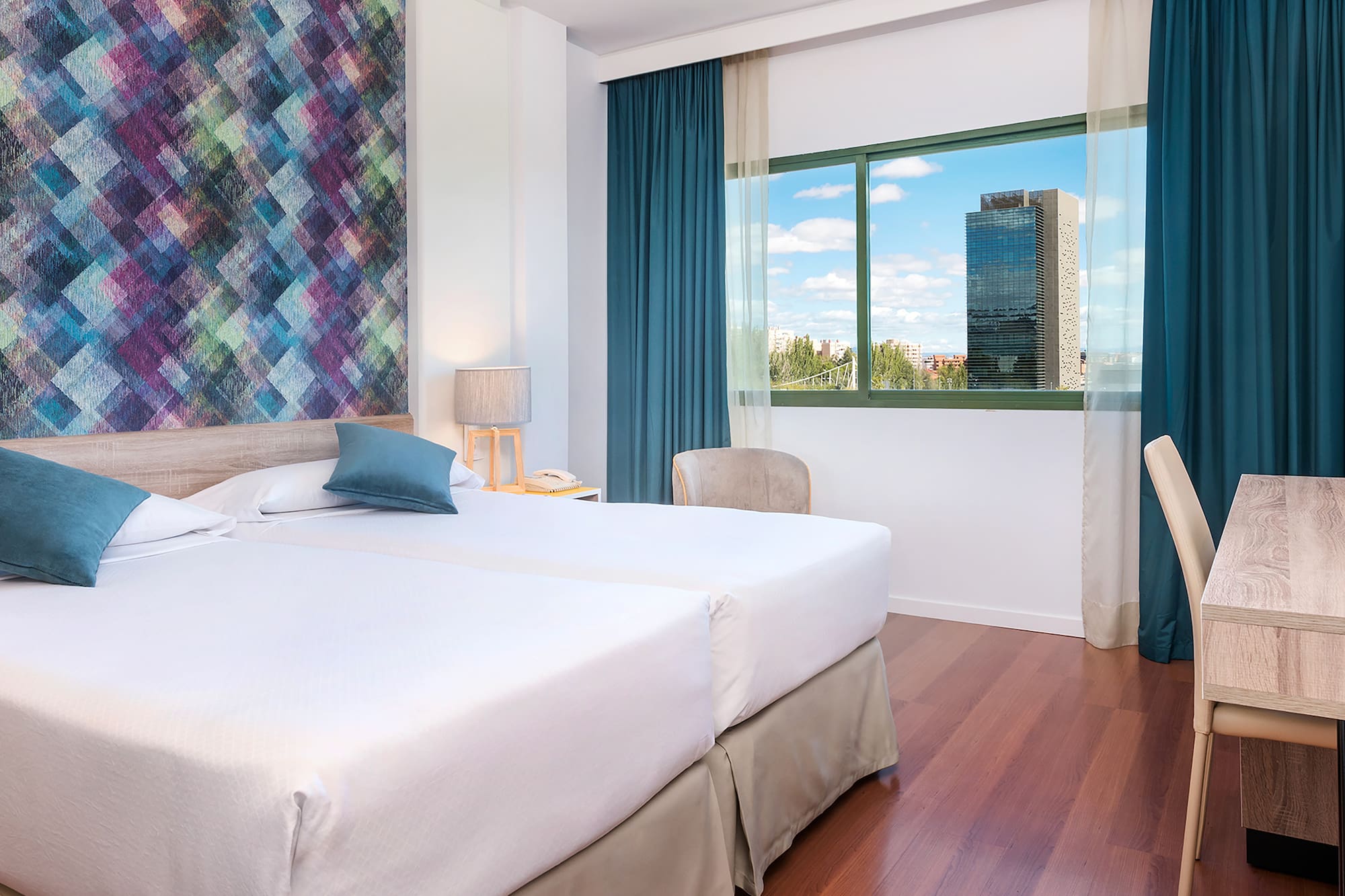 a room with two beds and a window