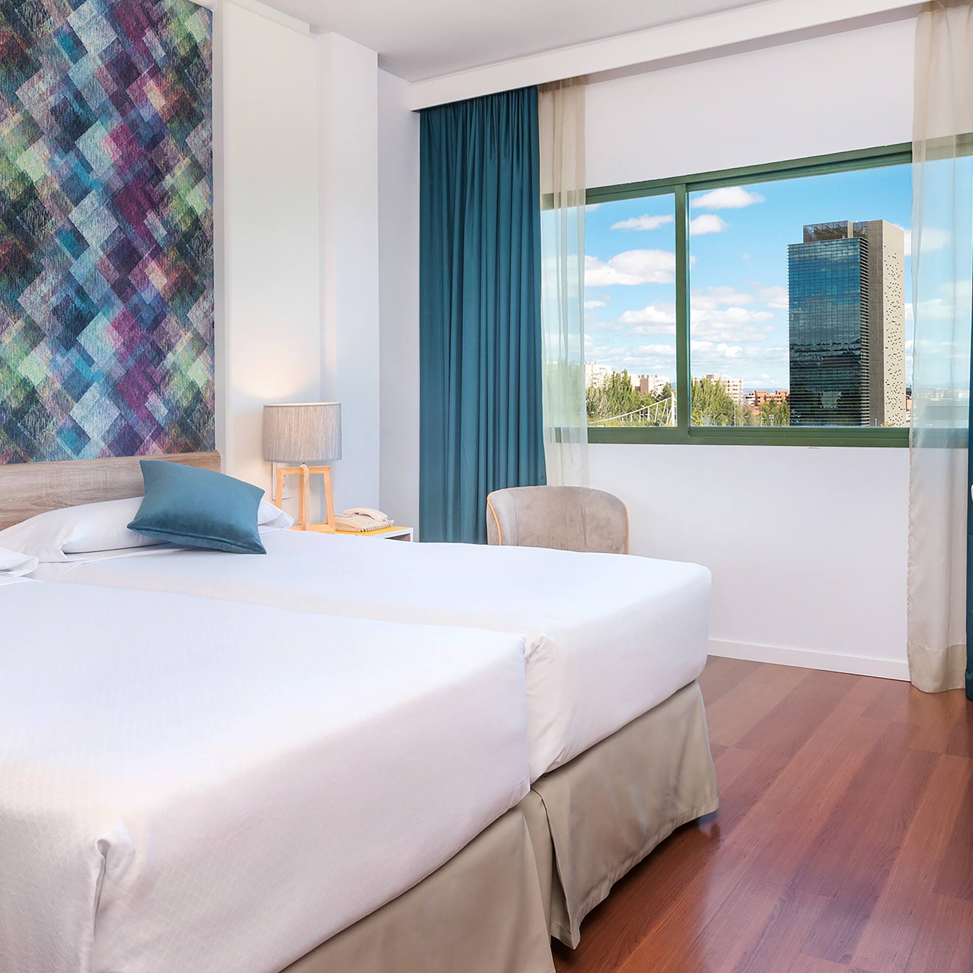 a room with two beds and a window