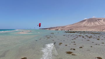 a person parasailing on a beach