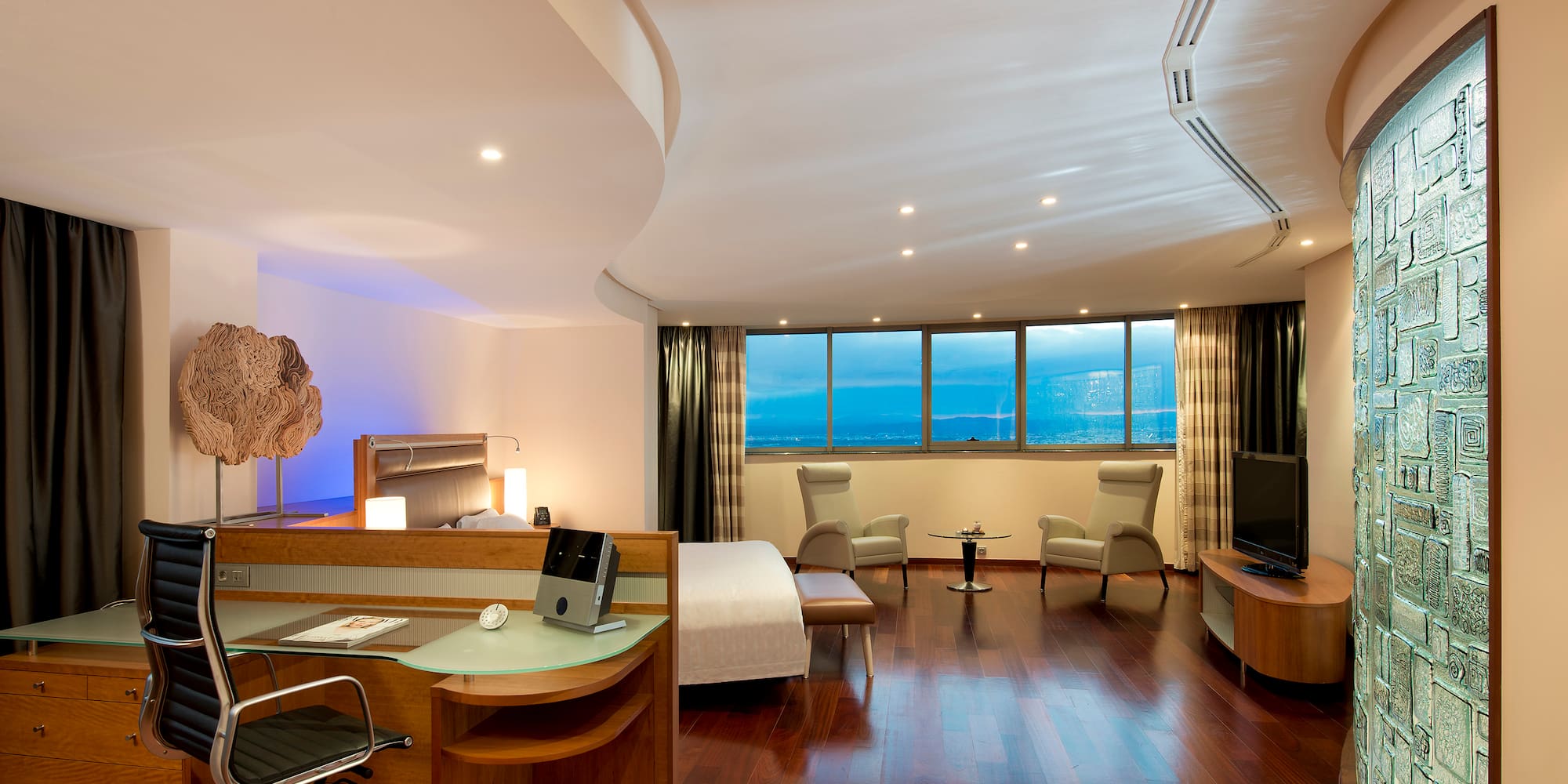 a room with a bed and a television