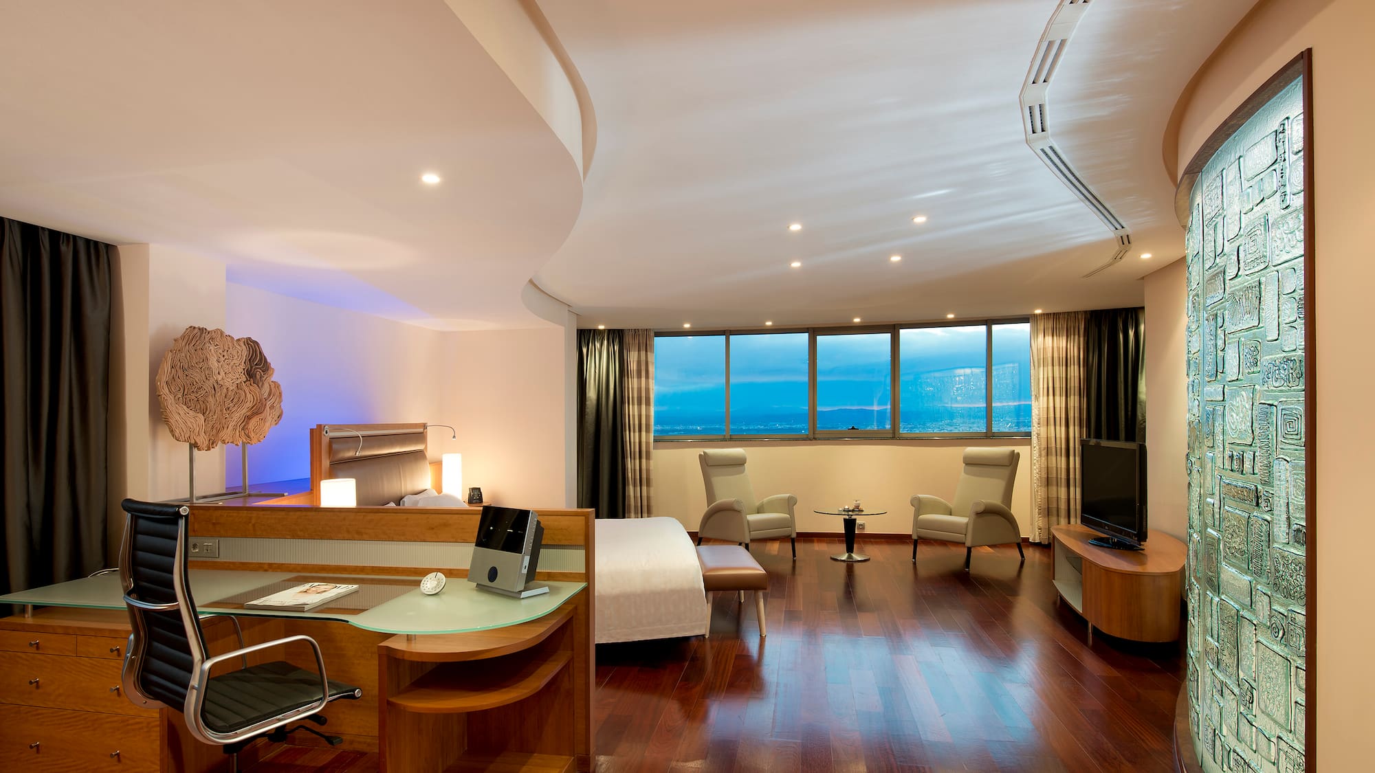 a room with a bed and a television