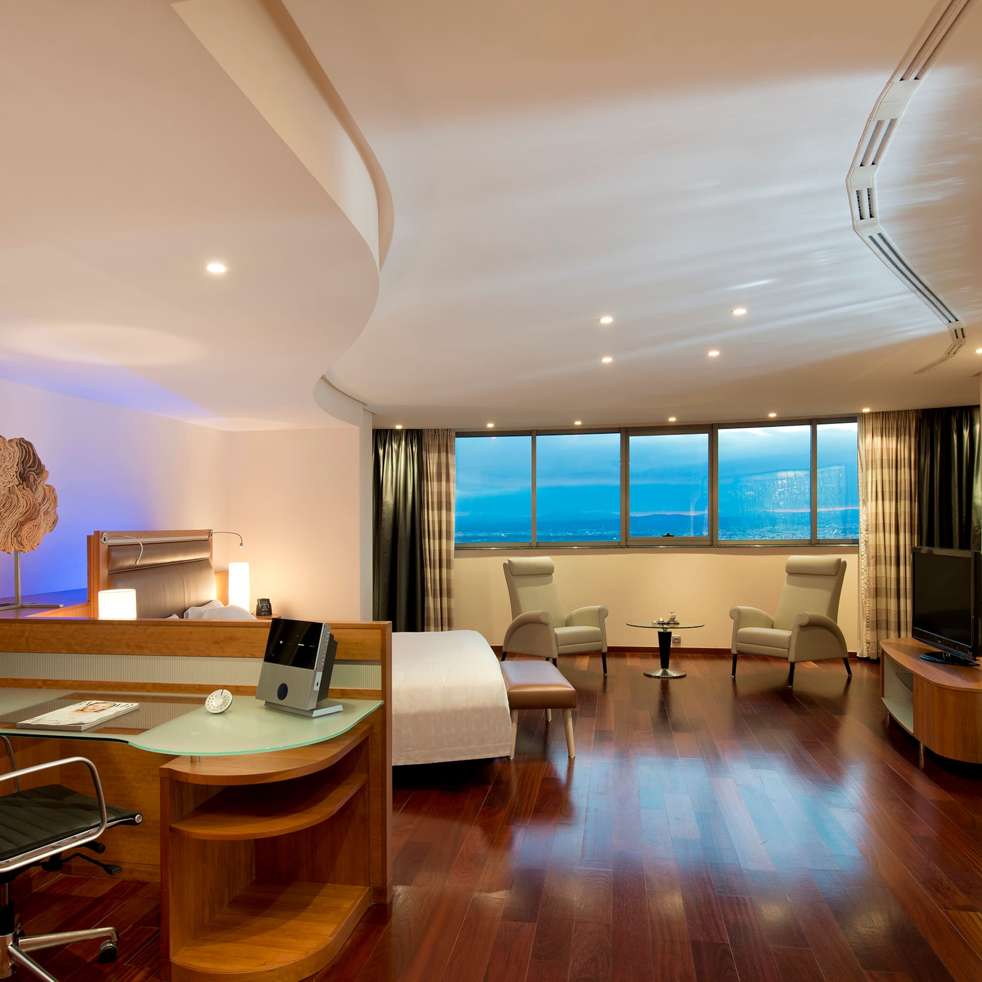 a room with a bed and a television