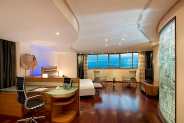 a room with a bed and a television