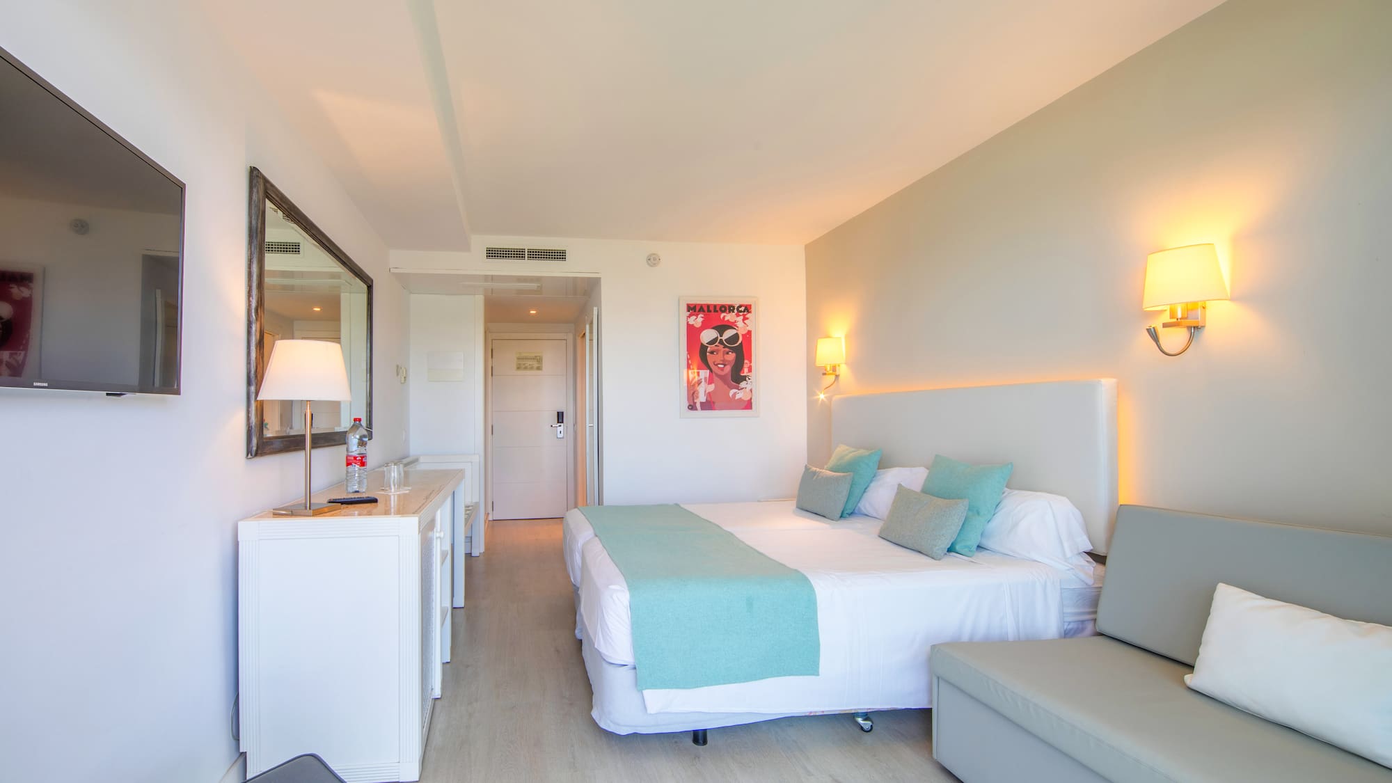 a bedroom with a bed and a couch