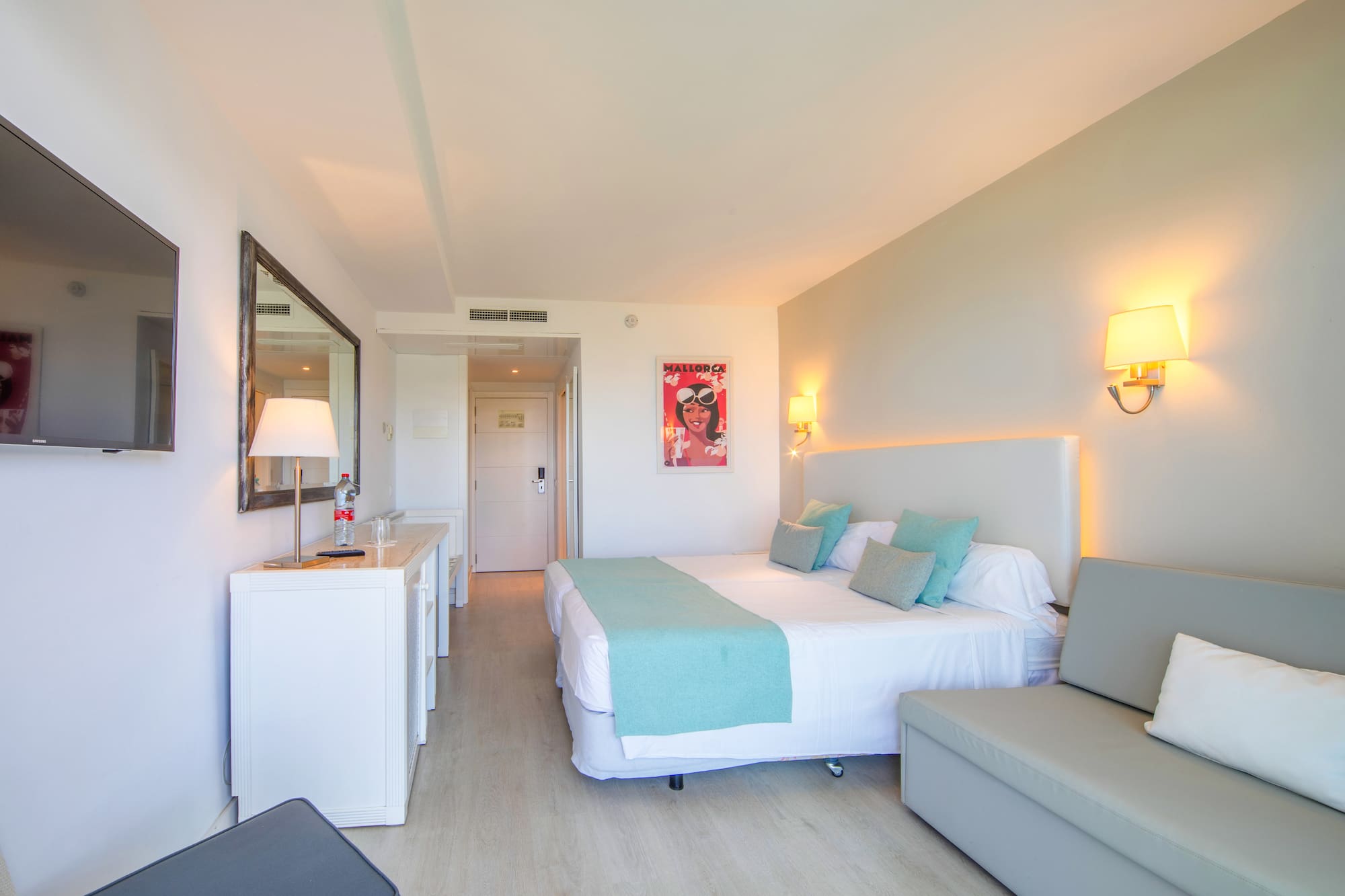 a bedroom with a bed and a couch