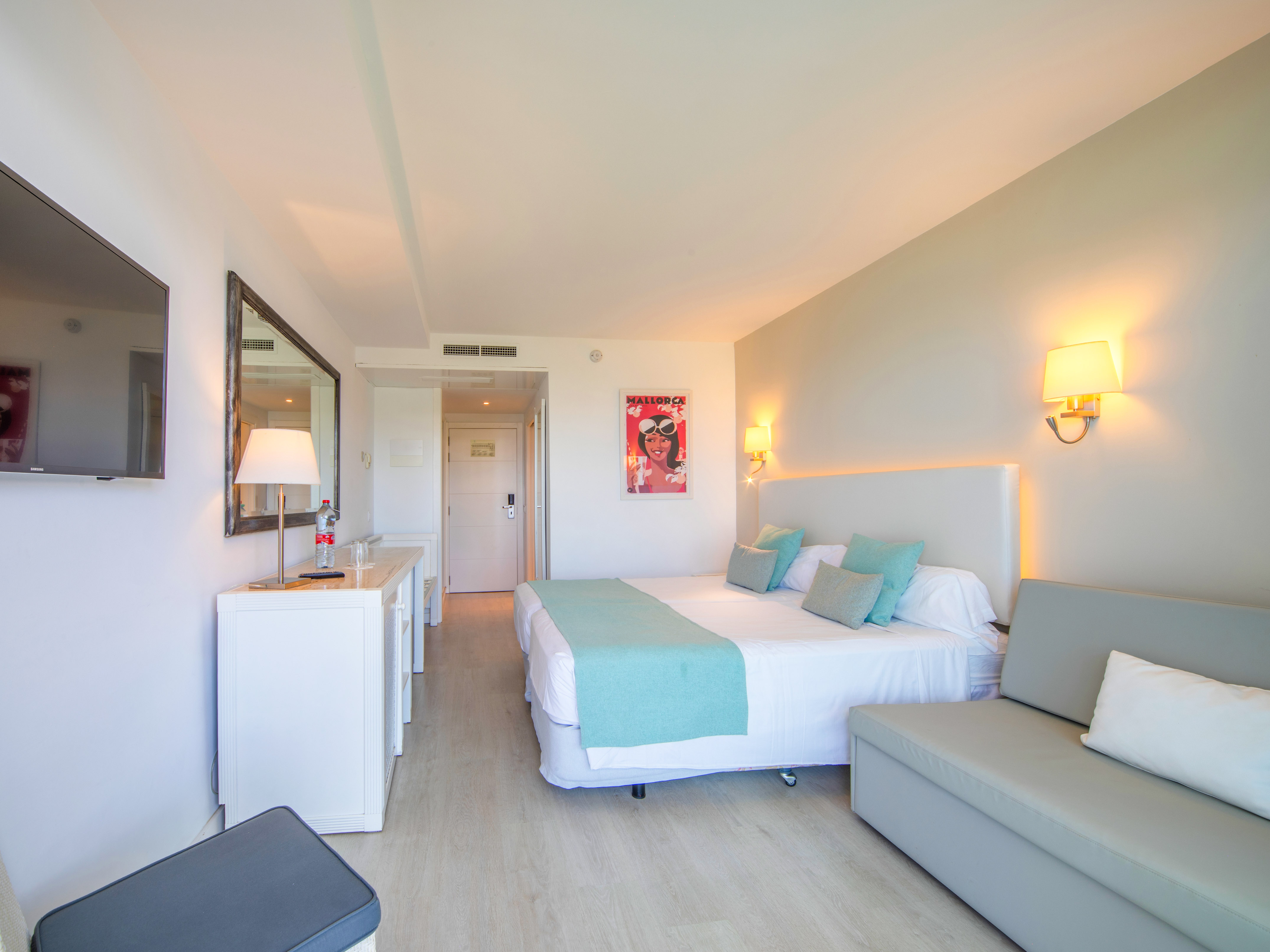 a bedroom with a bed and a couch