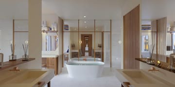 a bathroom with a tub and sinks