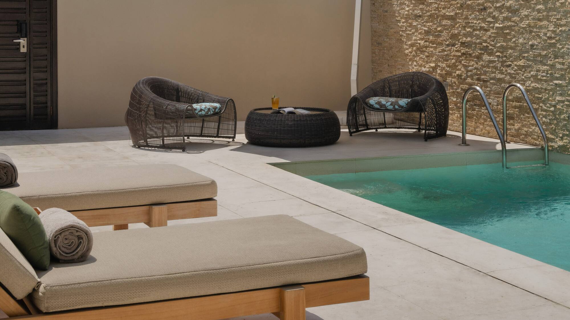 a pool with chairs and umbrella