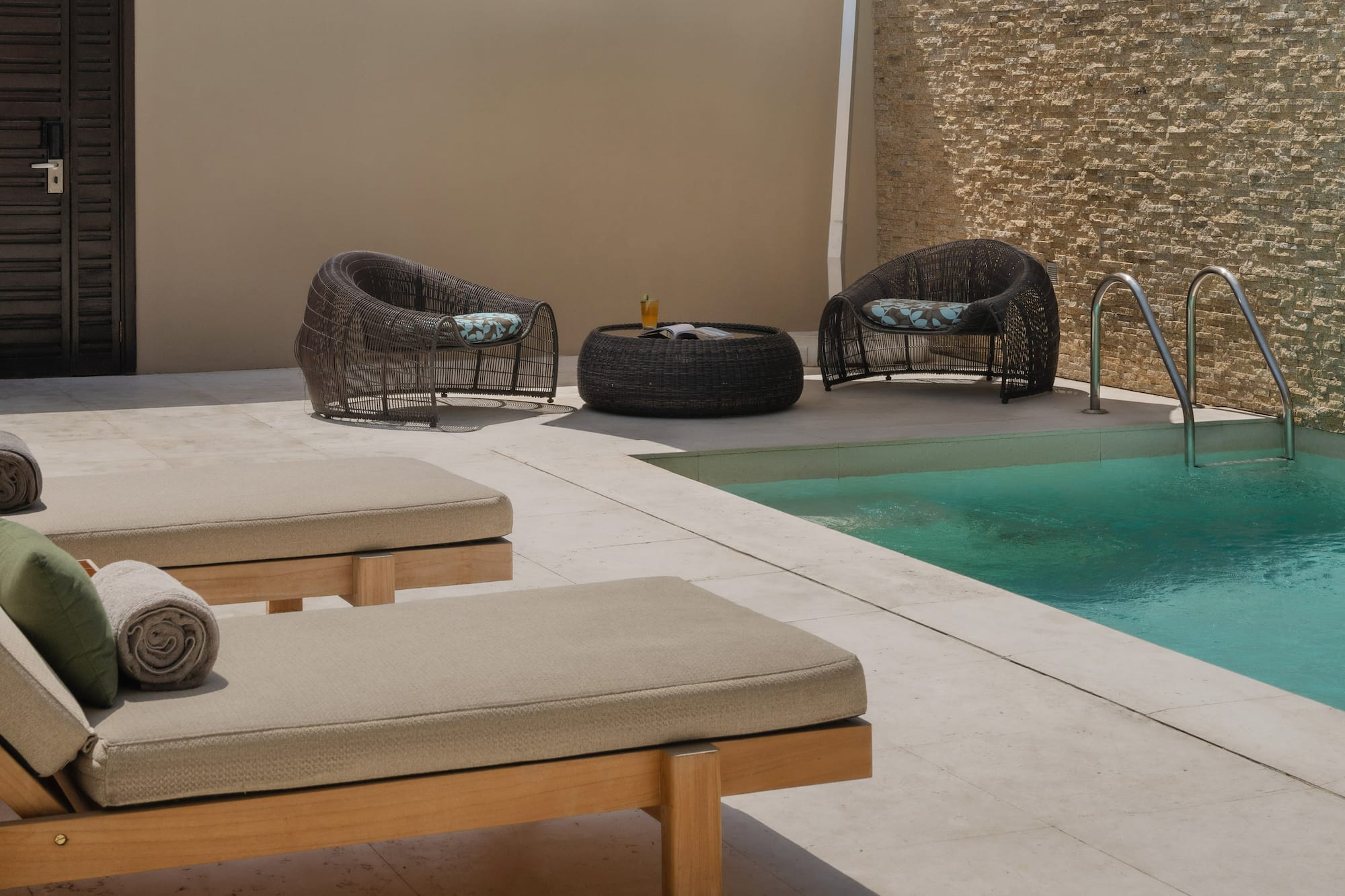 a pool with chairs and umbrella