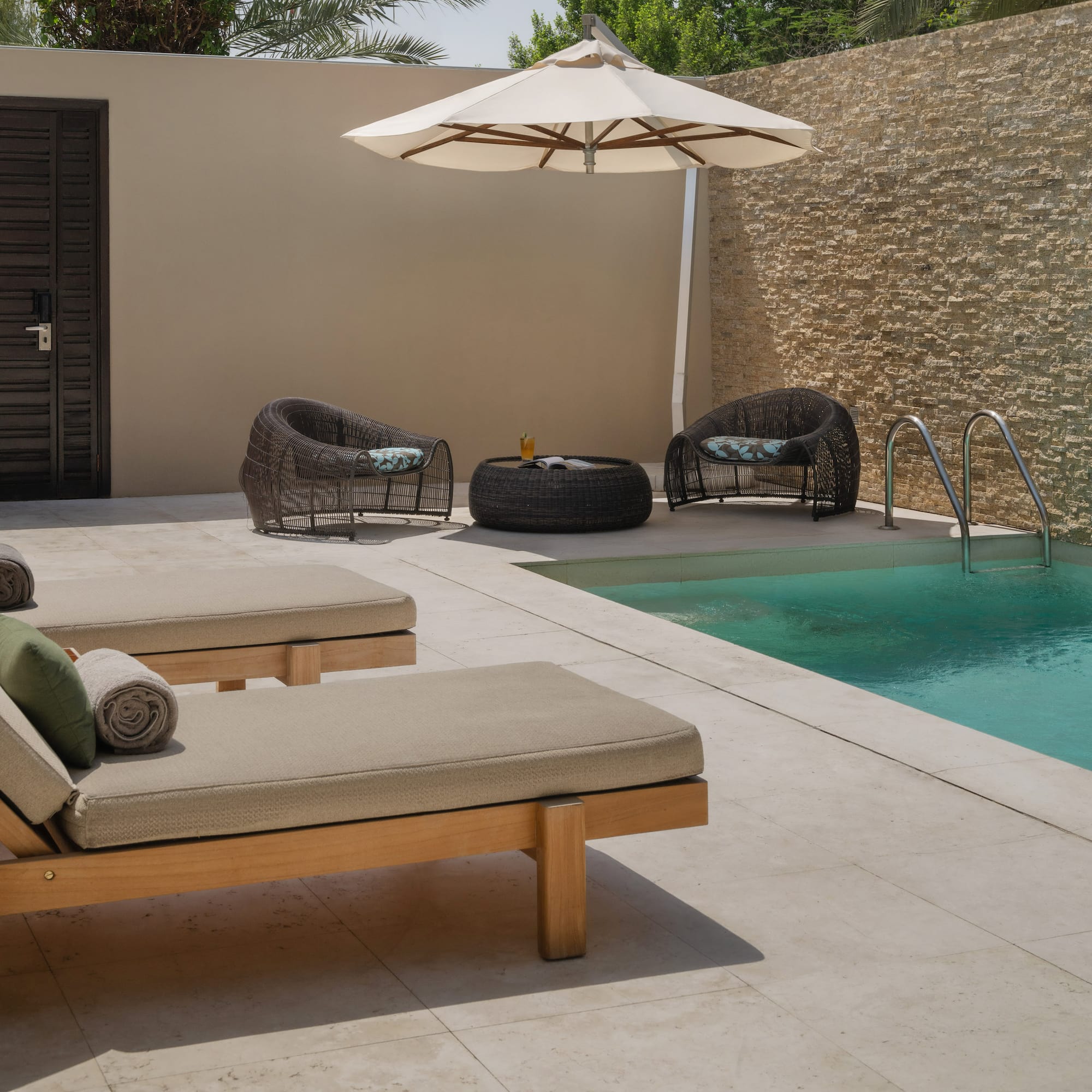 a pool with chairs and umbrella