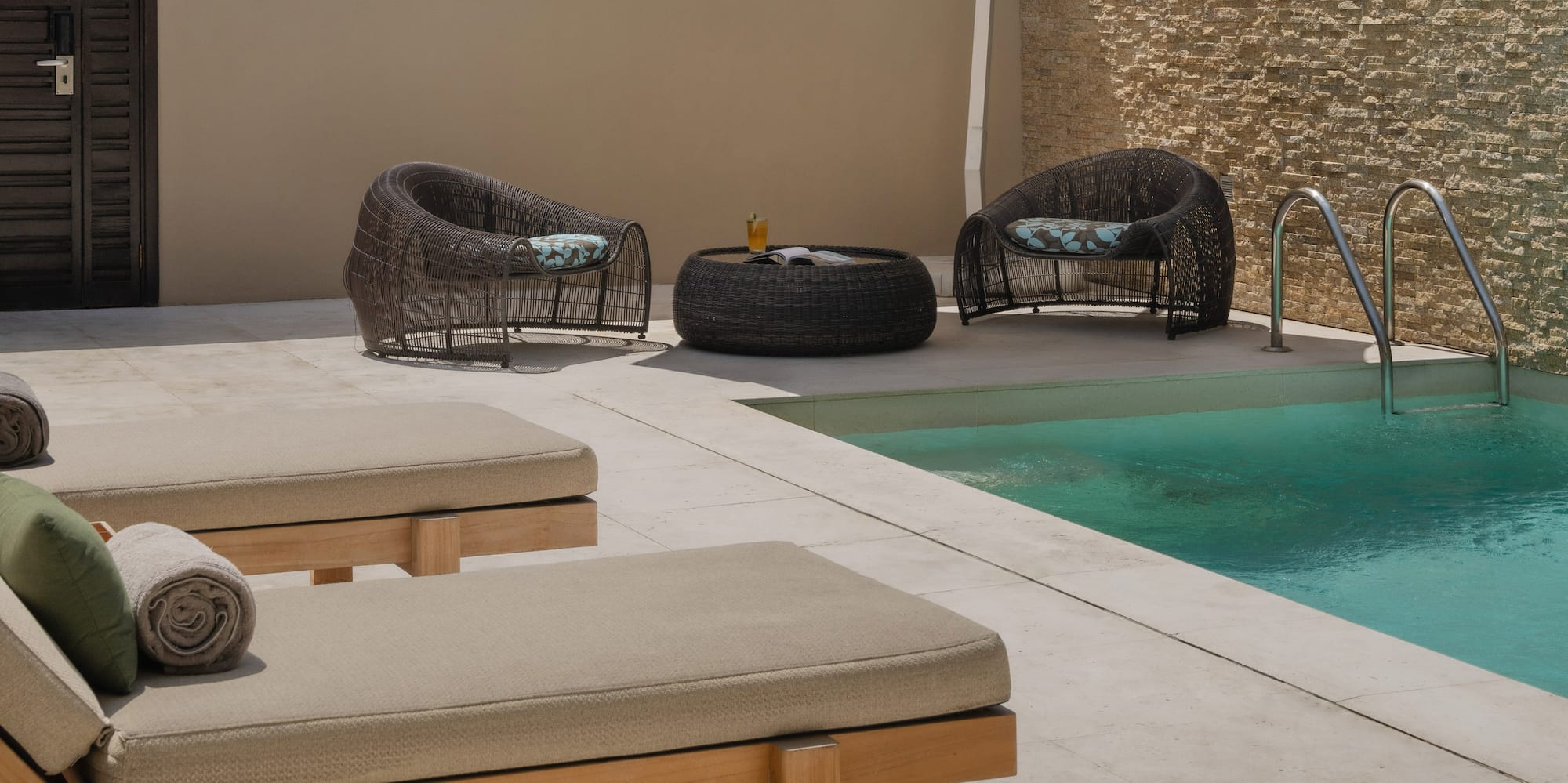 a pool with chairs and umbrella