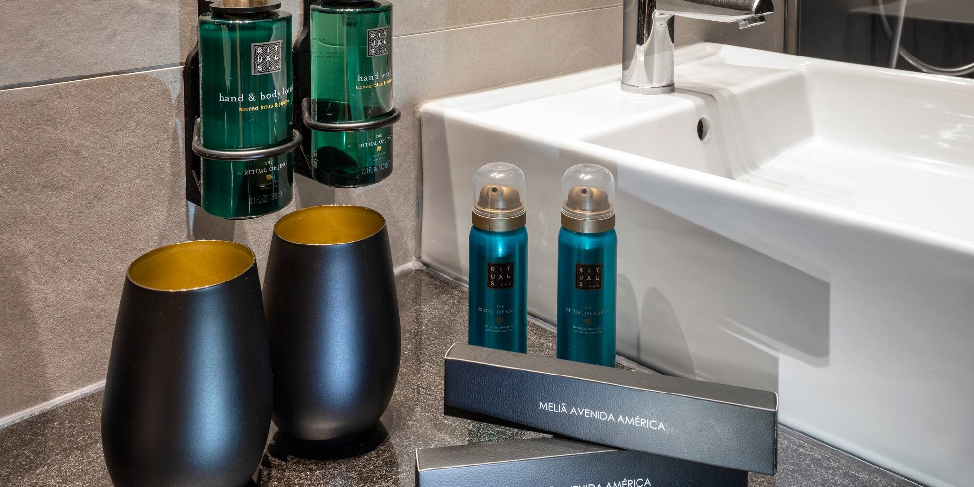 a bathroom sink with soap and shampoo bottles