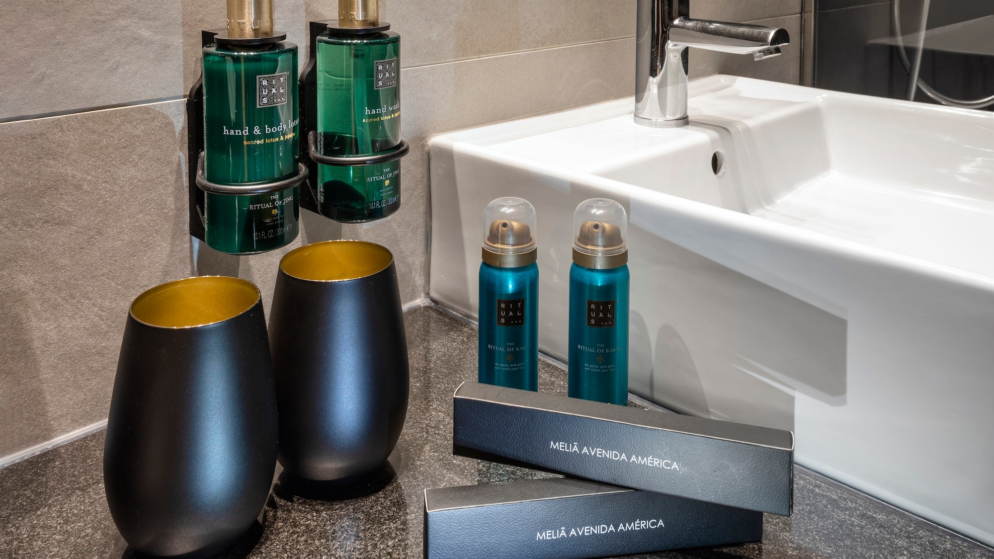 a bathroom sink with soap and shampoo bottles