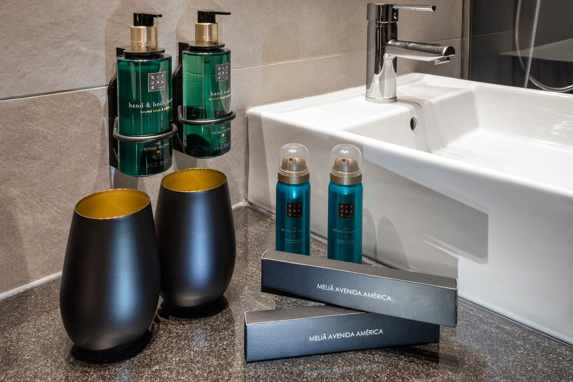a bathroom sink with soap and shampoo bottles