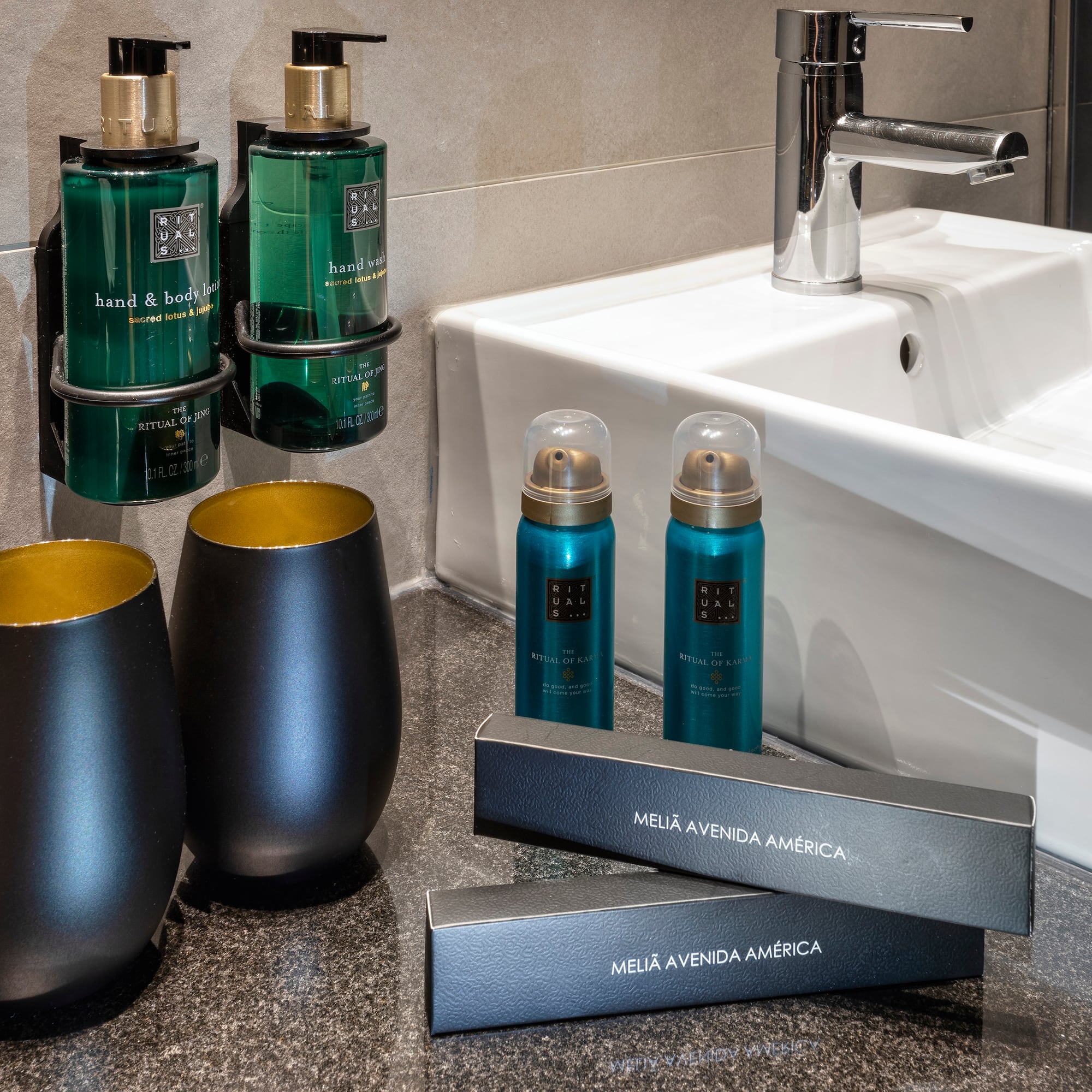 a bathroom sink with soap and shampoo bottles