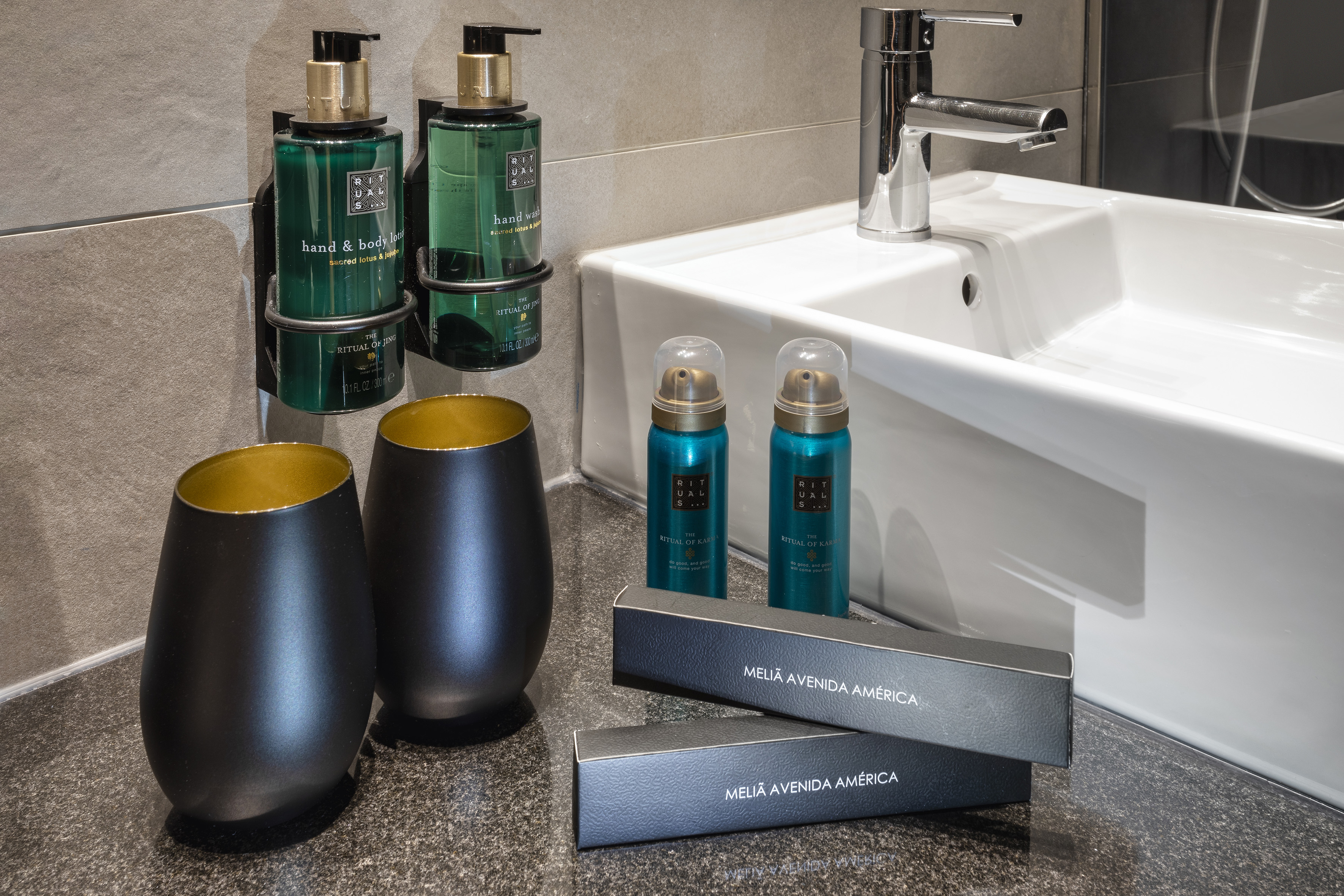 Hotel bathroom with Rituals hand wash, body lotion, and Meliá amenities.