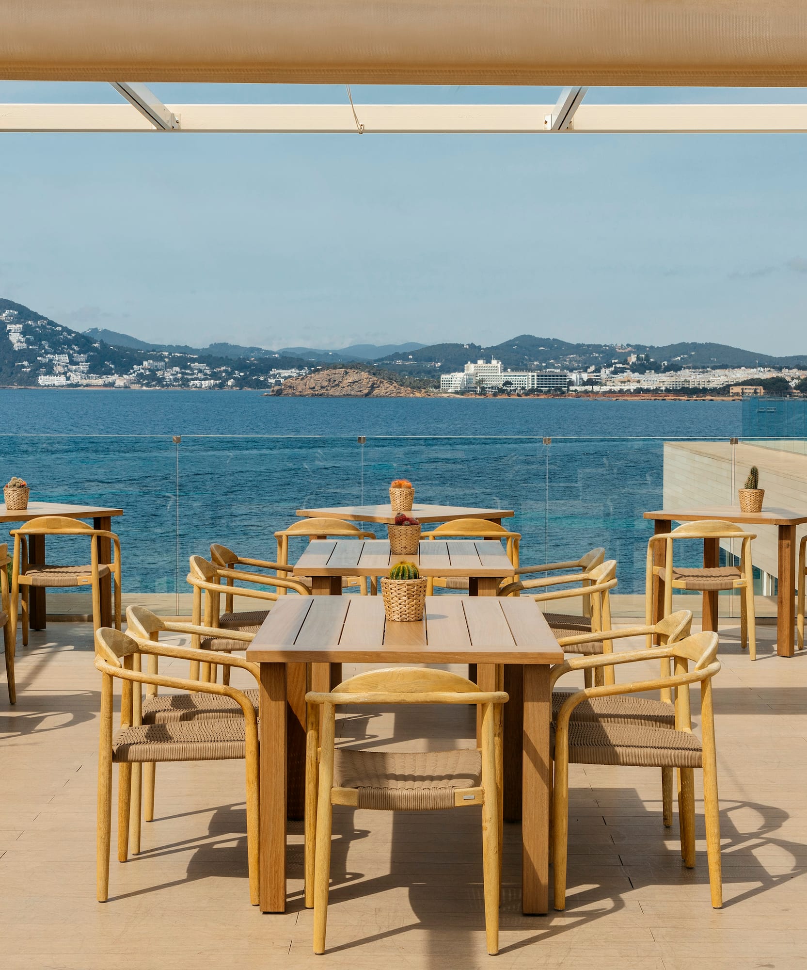 a table and chairs on a deck overlooking a body of water