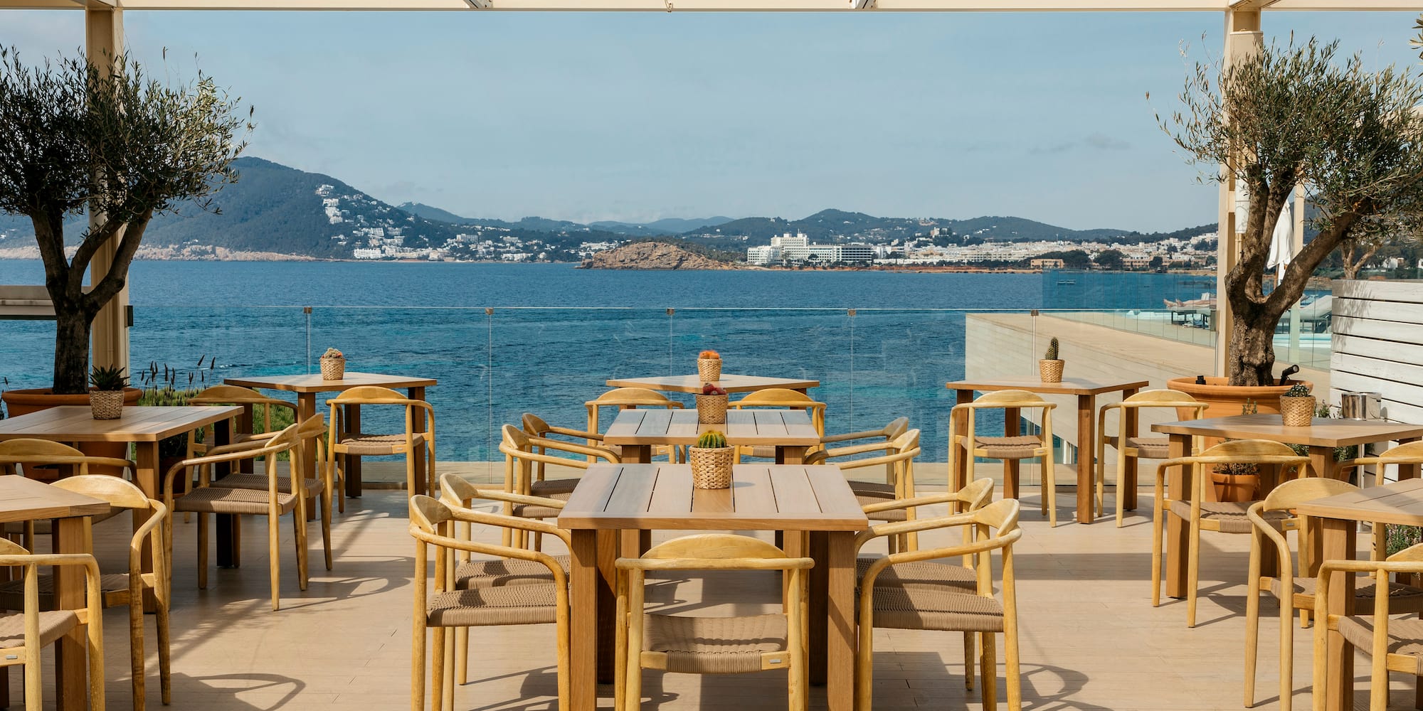 a table and chairs on a deck overlooking a body of water