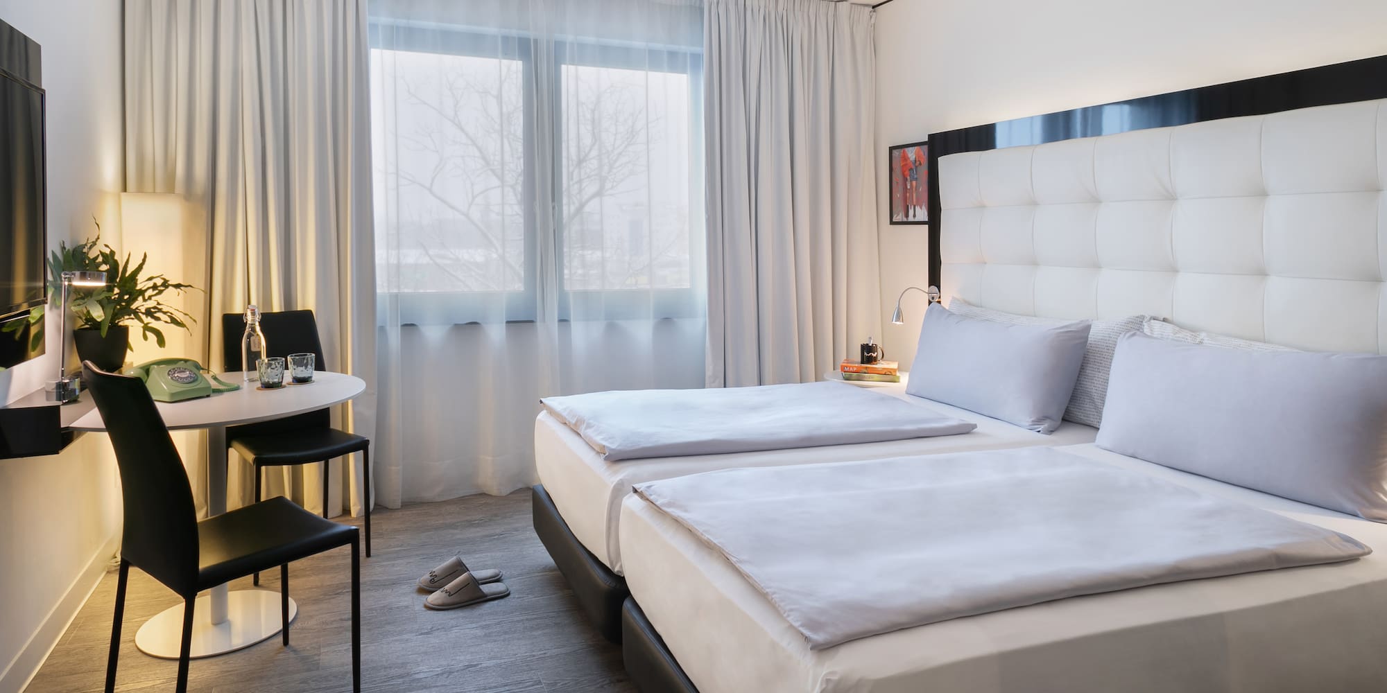 a room with two beds and a table