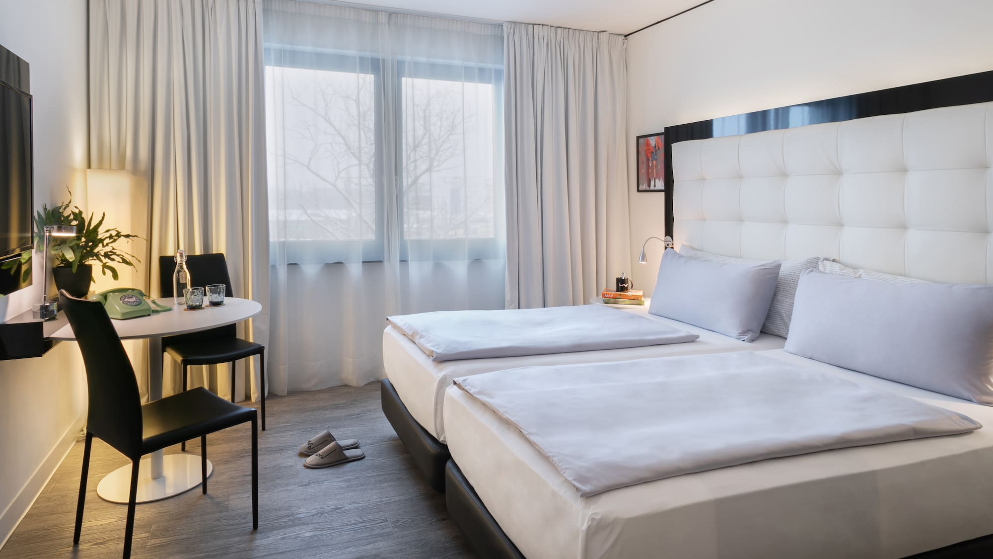 a room with two beds and a table