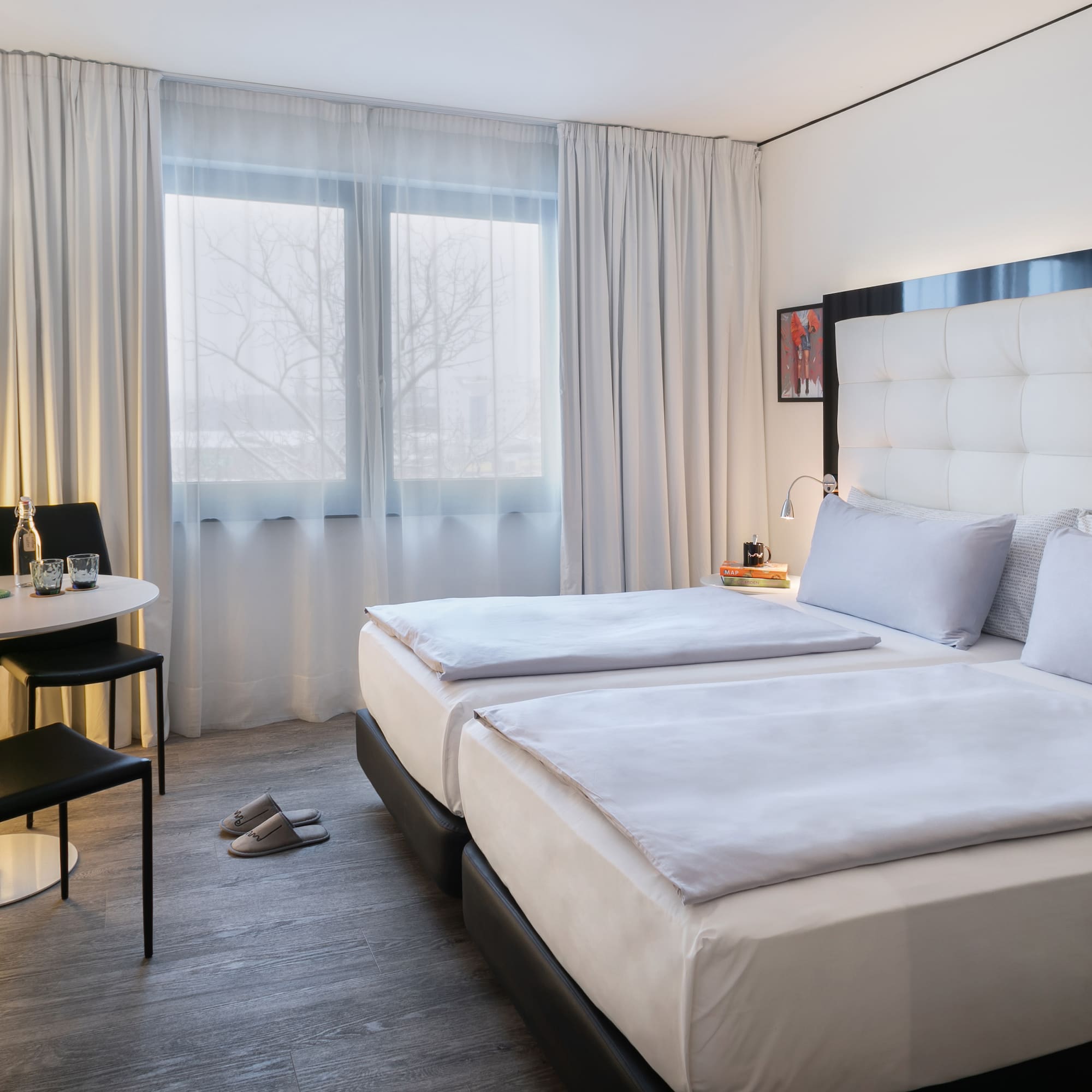 a room with two beds and a table